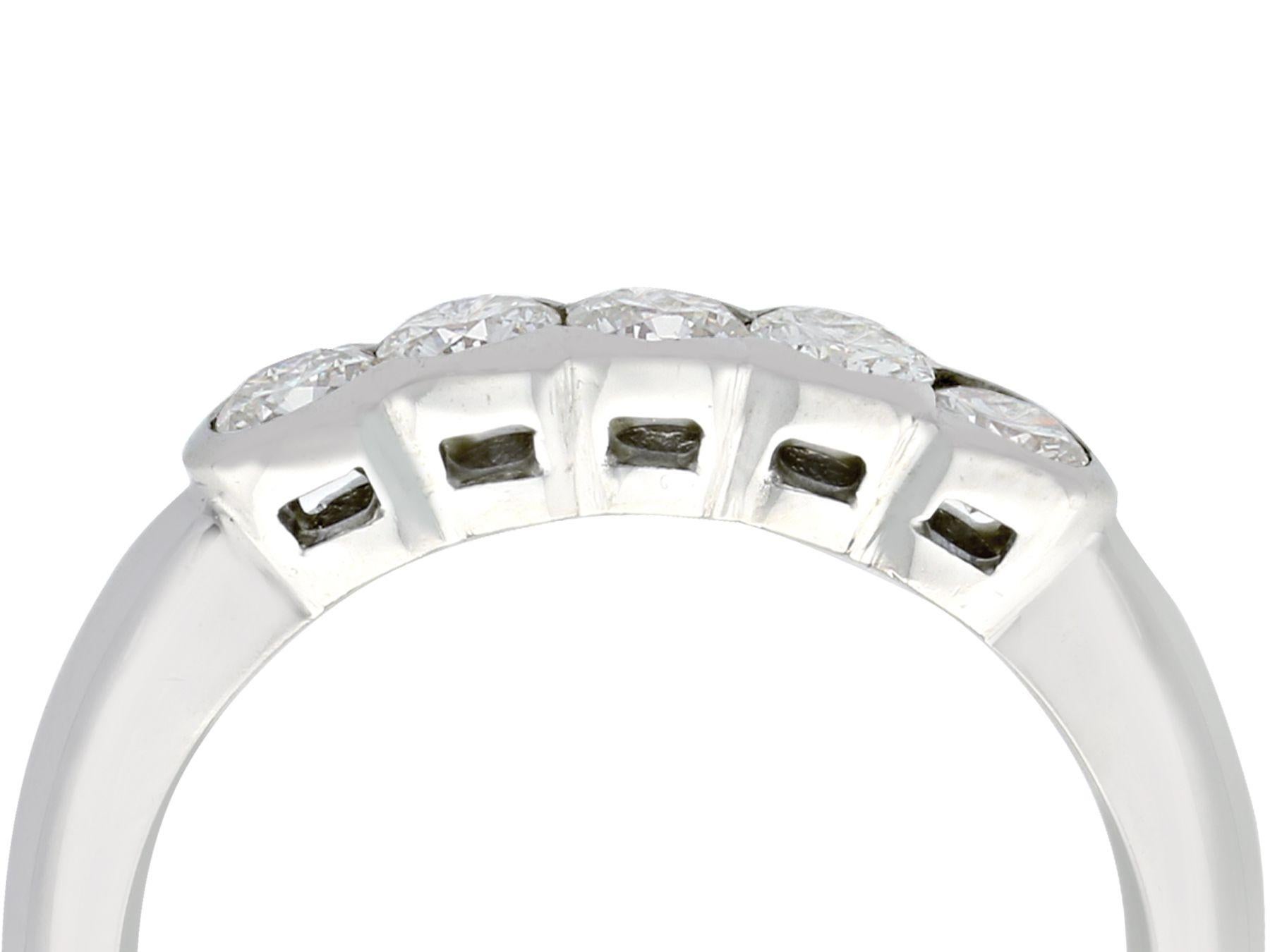 A fine and impressive contemporary 0.95 carat diamond and 18 karat white gold five stone ring; part of our contemporary jewelry and estate jewelry collections.

This impressive multi-diamond band ring has been crafted in 18k white gold.

The ring