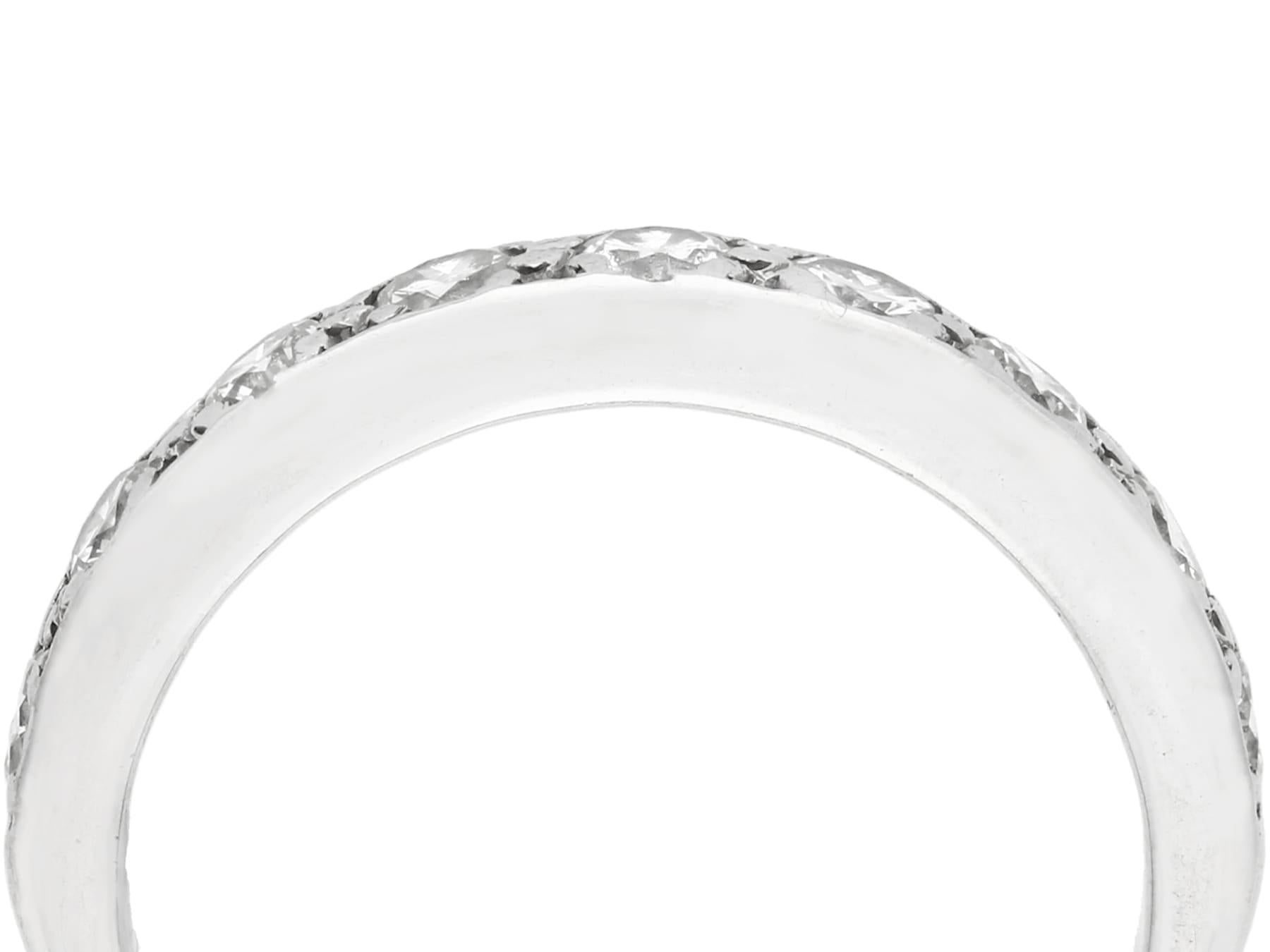 An impressive vintage 0.72 carat diamond and 18 karat white gold half eternity ring; part of our diverse diamond jewelry and estate jewelry collections.

This stunning, fine and impressive vintage eternity ring has been crafted in 18k white