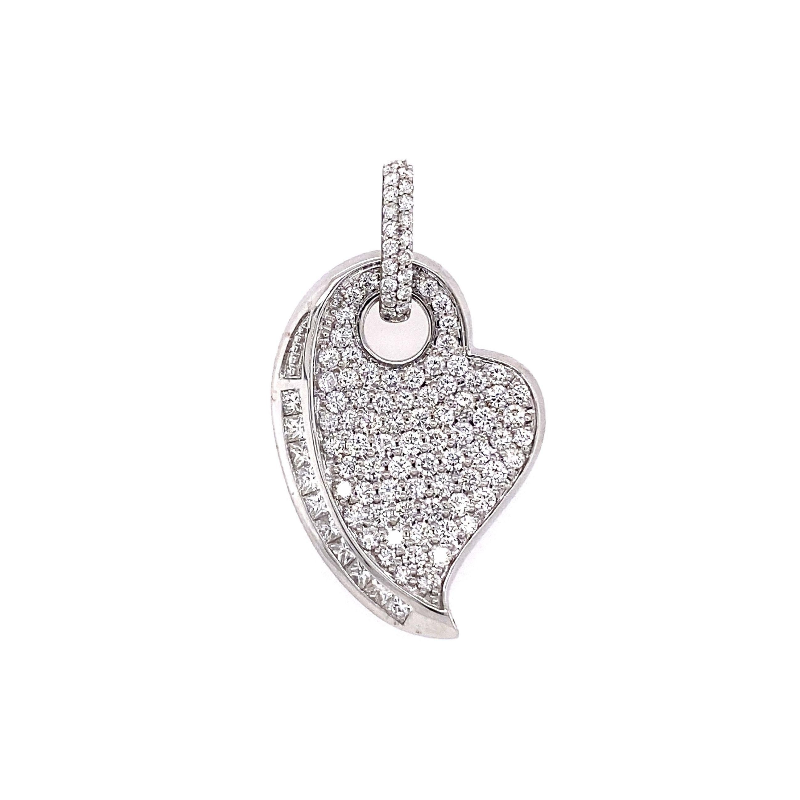 Simply Beautiful! Diamond Heart 18K Gold Pendant. Hand set Diamonds, weighing approx. 2.18tcw and Rubies approx. 1.48tcw. Hand crafted on the bias 18K White mounting. Pendant measures approx. 1.3”. long. More Beautiful in Real time…A sure to be