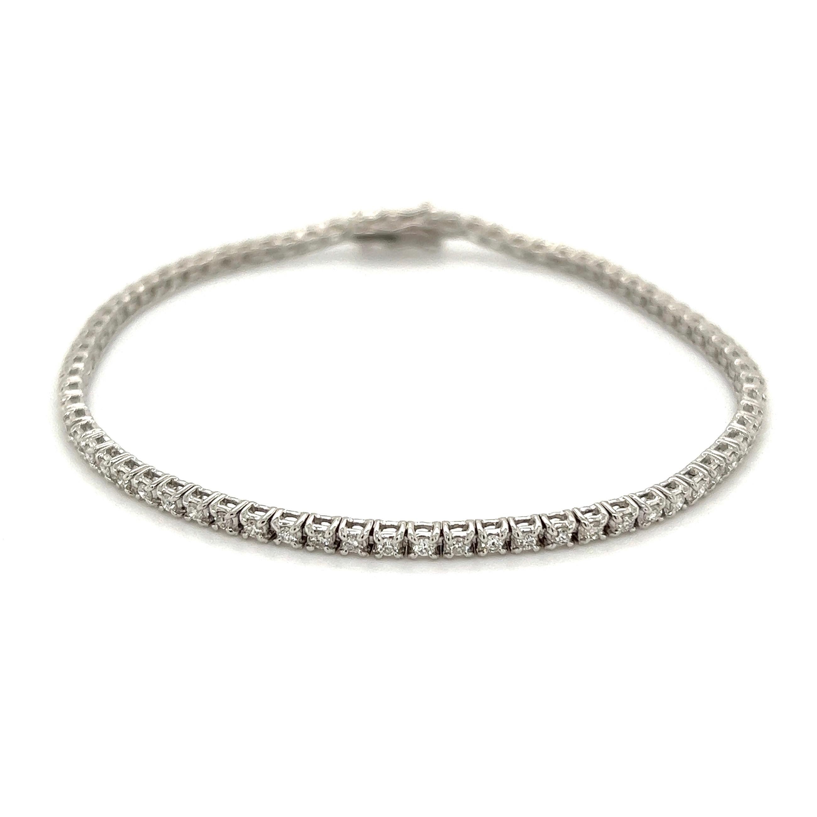 Simply Beautiful! Diamond 18K White Gold Line Tennis Bracelet. Hand set with Round Brilliant-Cut Diamonds, weighing approx. 1.00tcw. Measuring approx. 7” l x 0.09” w. Hand set and Hand crafted in 18K White Gold. Chic and Classic and so easy to