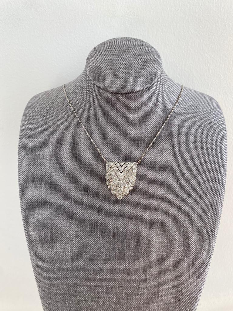 Elegant  Art deco pin mounted as a necklace with a forcat chain made with 18 carats white gold and circa 3 carats of diamonds. Paving of 79 extra white diamonds with geometric motifs (diameter circa 1,5 and 3 mm). The clarity is SI1/SI1, diamond
