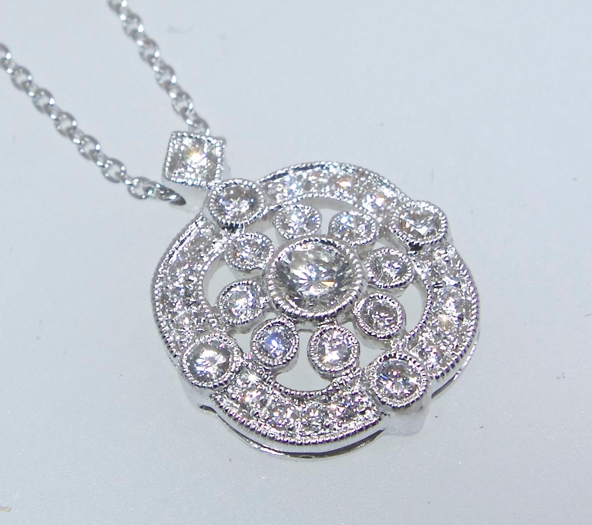 The diamond encrusted pendant is well made and a sparkling statement for the neck.  It is well made with .65 cts of fine white diamonds - all well cut and well matched, near colorless (H) and very slightly included (VS).  This pendant is .5 inches