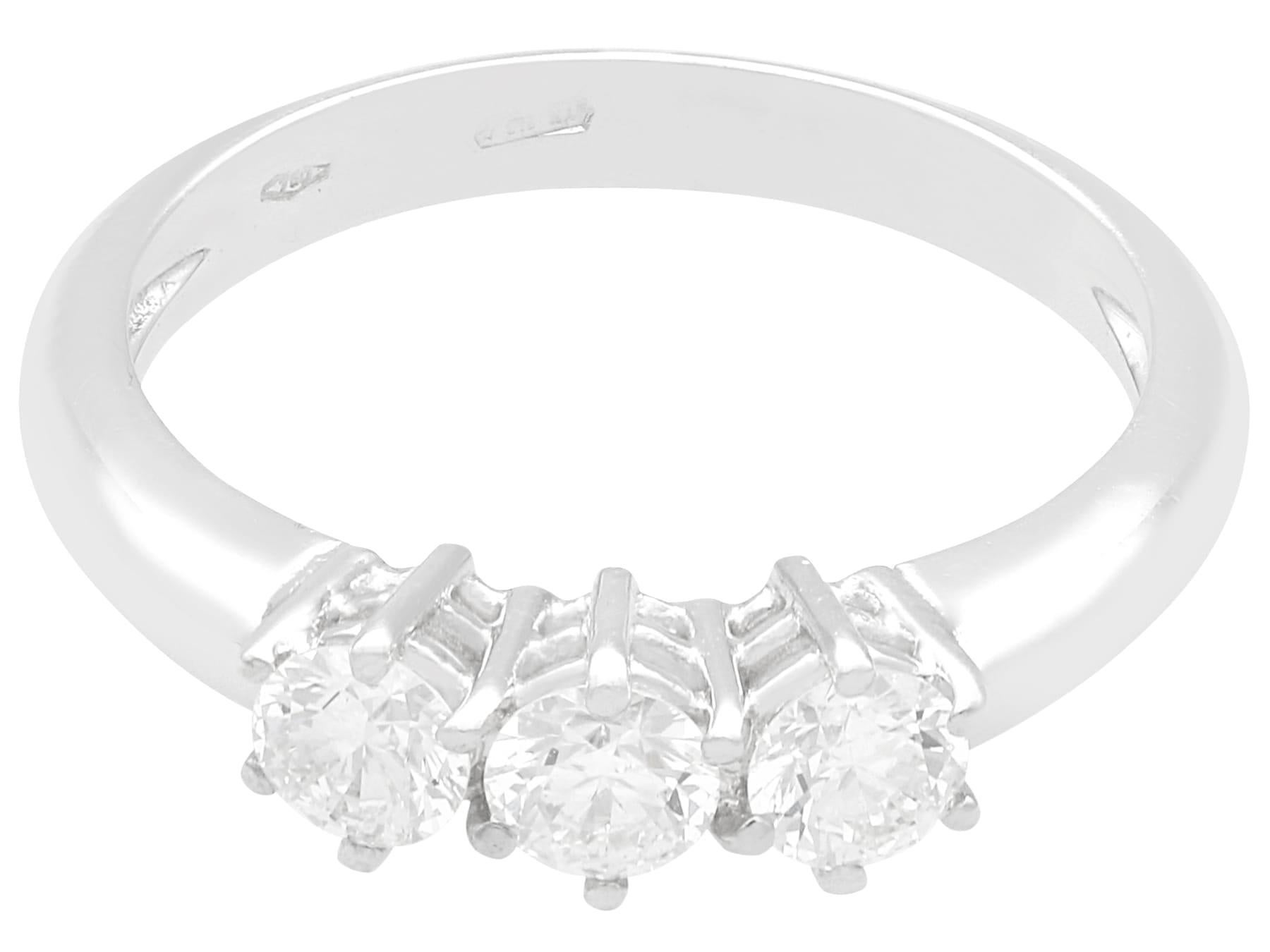 A fine and impressive 0.84 carat modern brilliant round cut diamond trilogy ring in 18 karat white gold; part of our contemporary jewelry and estate jewelry collections

This fine and impressive contemporary diamond trilogy ring has been crafted in