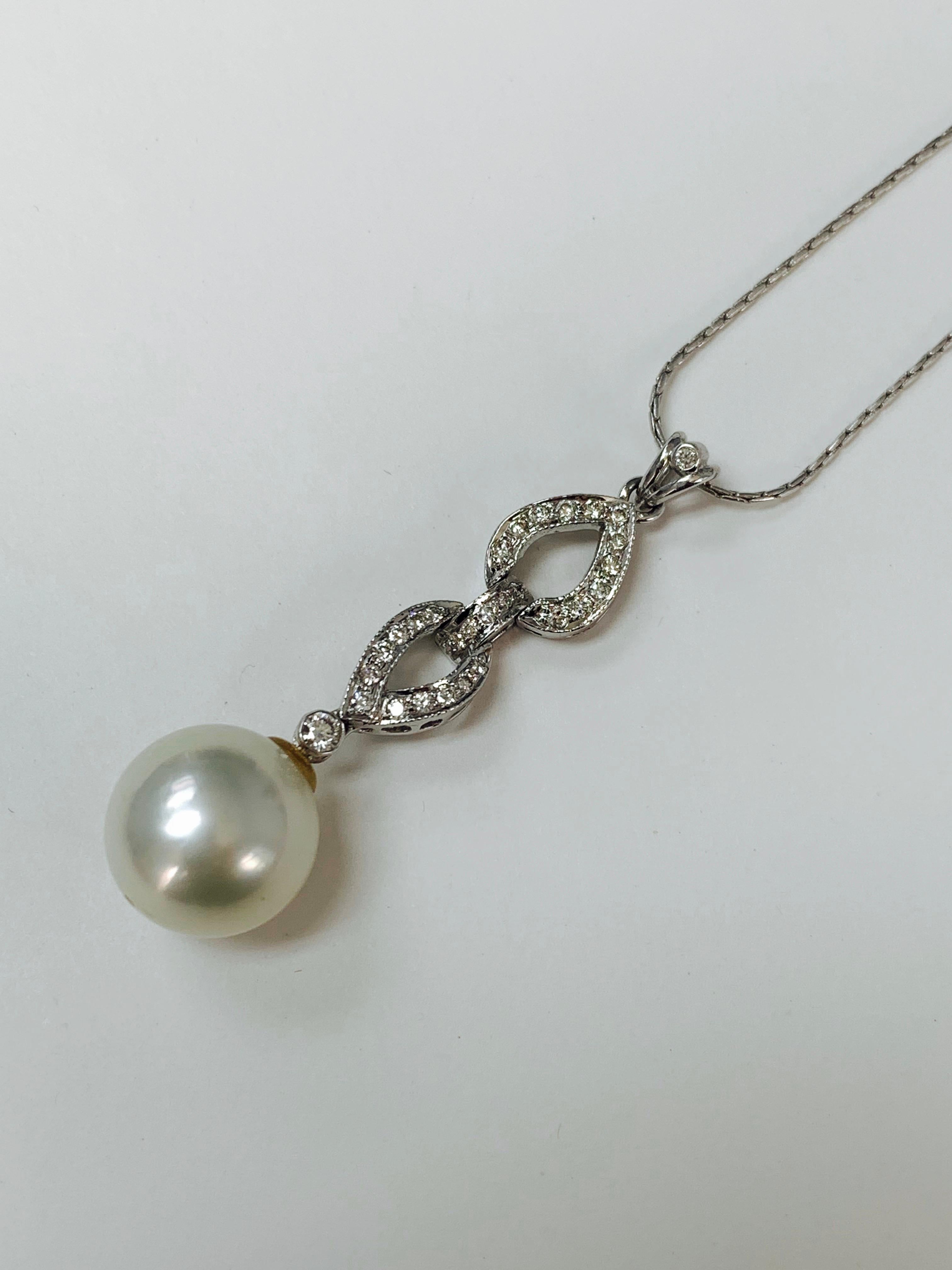 Very classy diamond and south sea pearl pendant In 18K white gold.
The details are as follows : 
Diamond  weight : 0.53 carat ( GH color and VS clarity ) 
South Sea Pearl : 12.4mm 
Measurements : 1 3/4 inches 
Metal : 18k white gold 