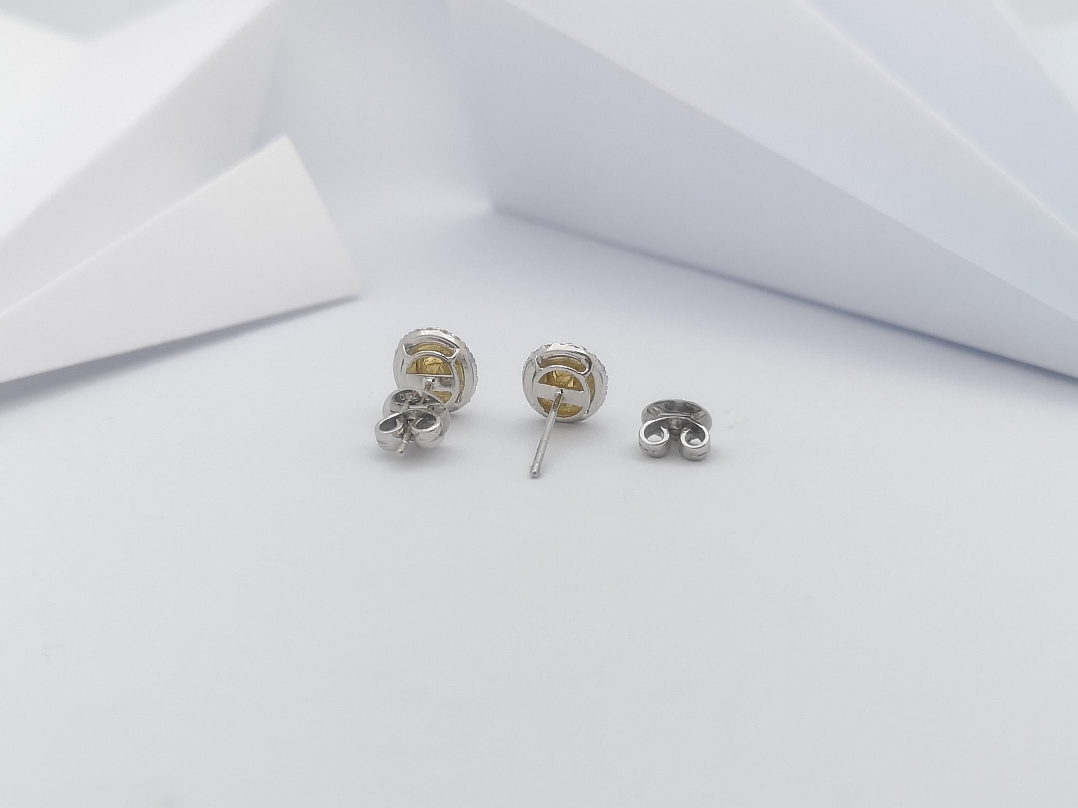 Women's Diamond and Yellow Diamond Earrings Set in 18 Karat White Gold Settings For Sale
