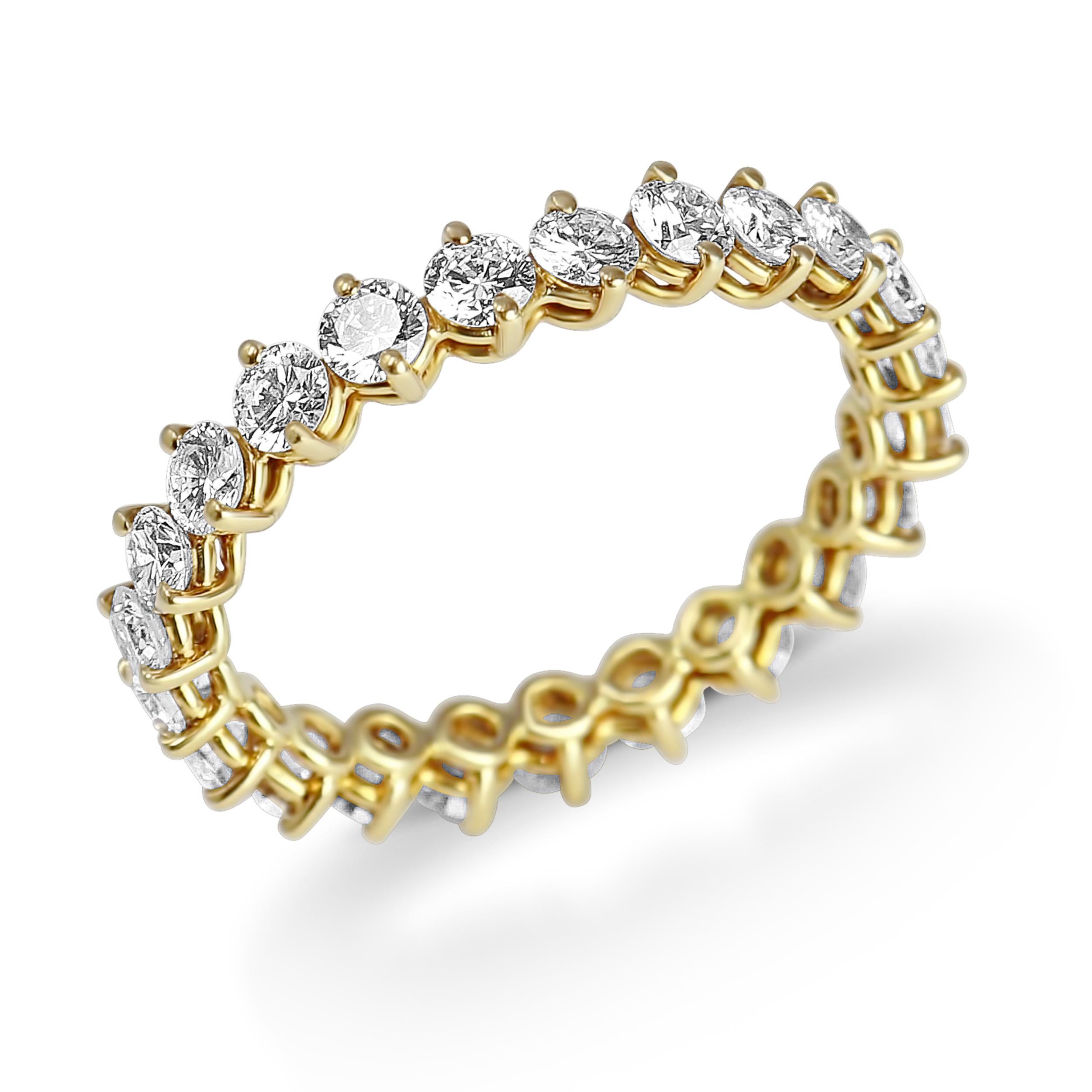 This elegant eternity band by Kurt Wayne is a stunning complement to any engagement ring or is beautiful worn on its own. The band contains 23 2.7mm round diamonds,  G/H color and VS2 clarity, 1.87 carats total. The ring is crafted in 18K yellow