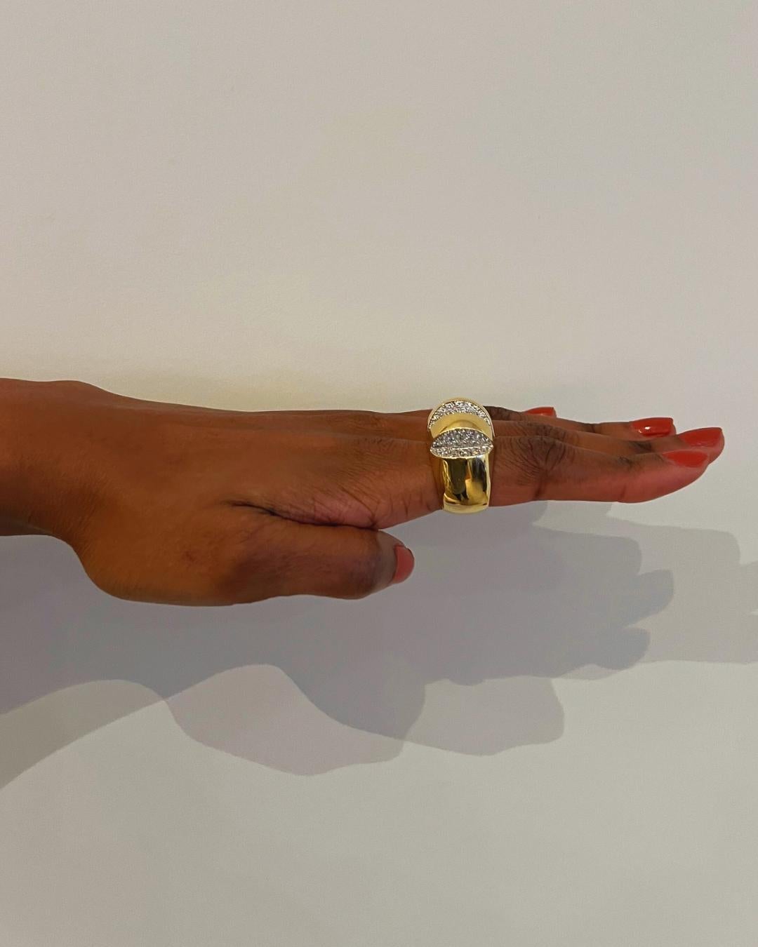 This is the cocktail ring to own, a true showstopper beautifully crafted in rich yellow gold and diamonds. It is a diamond pave and 18-karat gold cut-out ring, c. 1980, a rich gold circle sliced open to reveal several parts. The ring has
