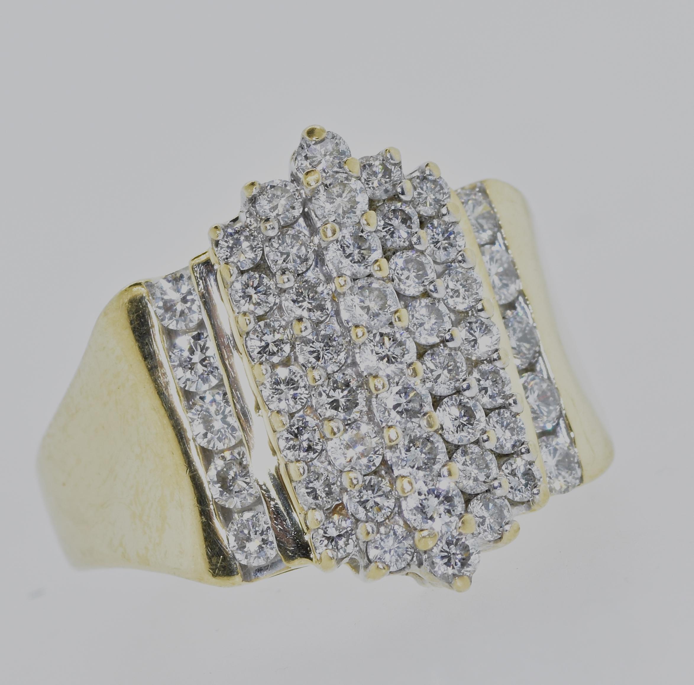 White Diamond and yellow gold ring possessing fine white brilliant cut diamonds.  The 49 diamonds are near colorless (H/I) and slightly included, the estimated diamonds weight by our in-house gemologist is 1.75 cts.  The top of this ring measures