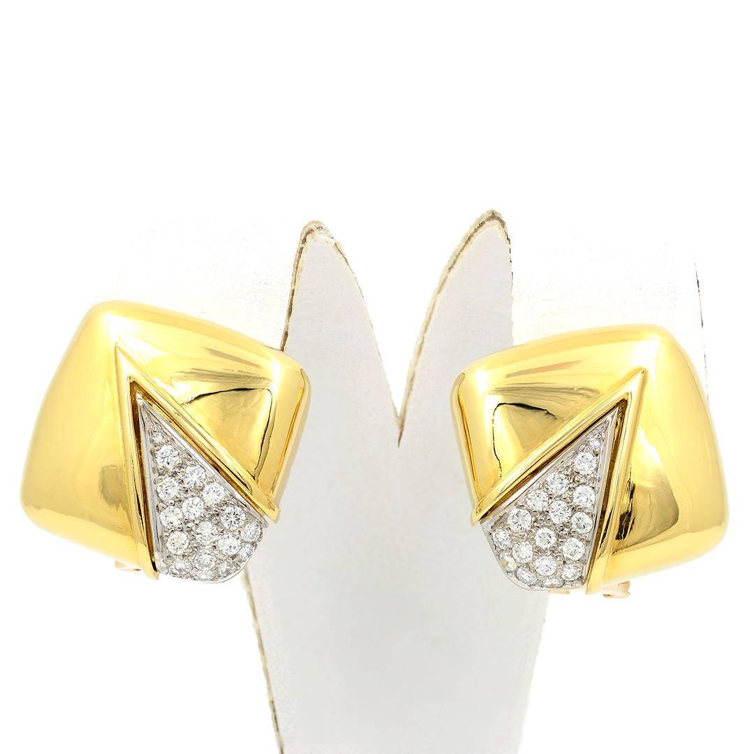 These 18 karat yellow gold high polish earrings have a cushion shape. The corners are accented with 34 round brilliant cut diamonds weighing approximately 0.68 carats, with G coloring, and VS clarity. The earrings have omega post backs. 