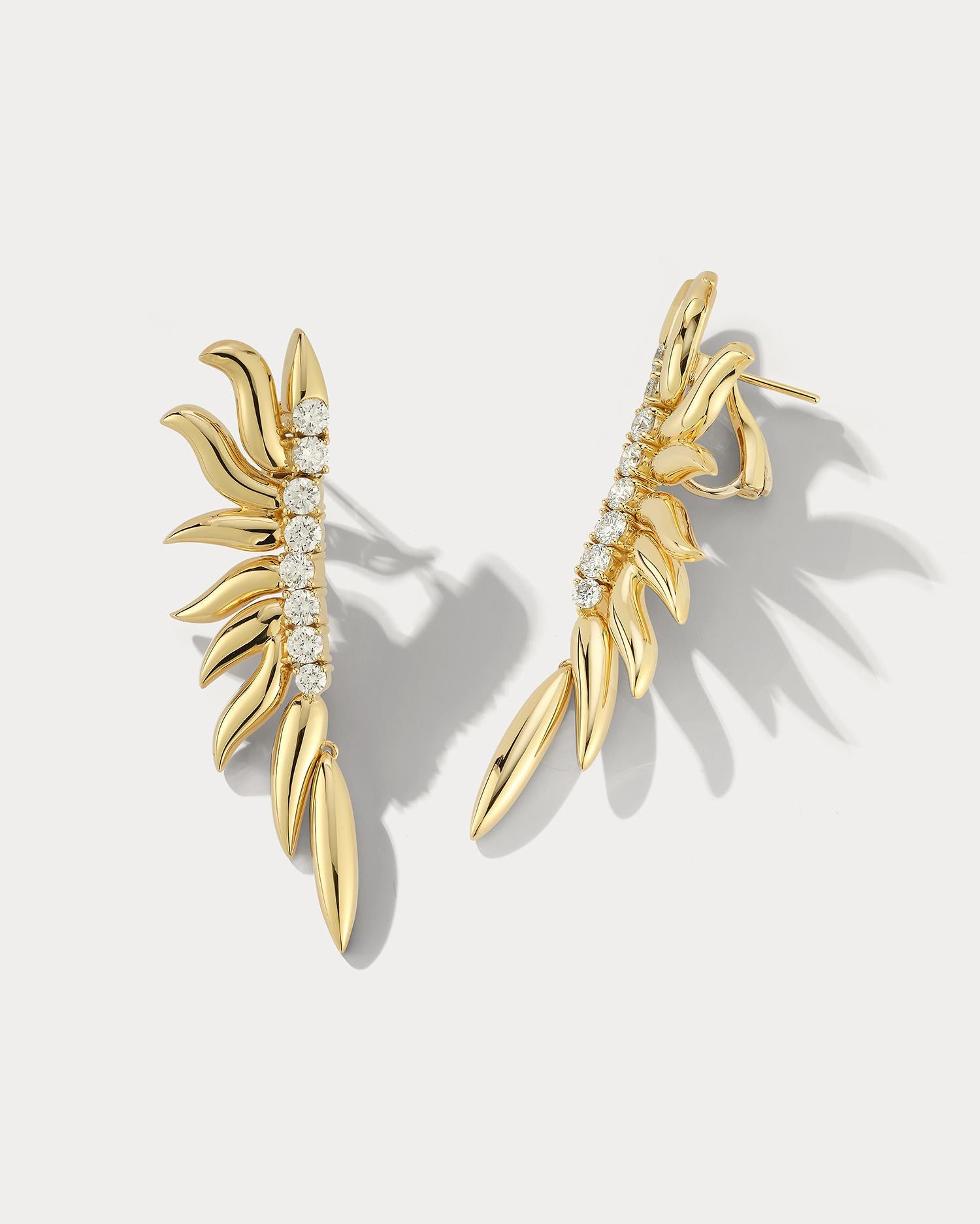 Flame Yellow Gold and Diamond Earrings are a luxurious and elegant pair of earrings designed to add a touch of sophistication to any outfit. They are crafted from high-quality 18k yellow gold, known for its durability and beautiful, warm color. They
