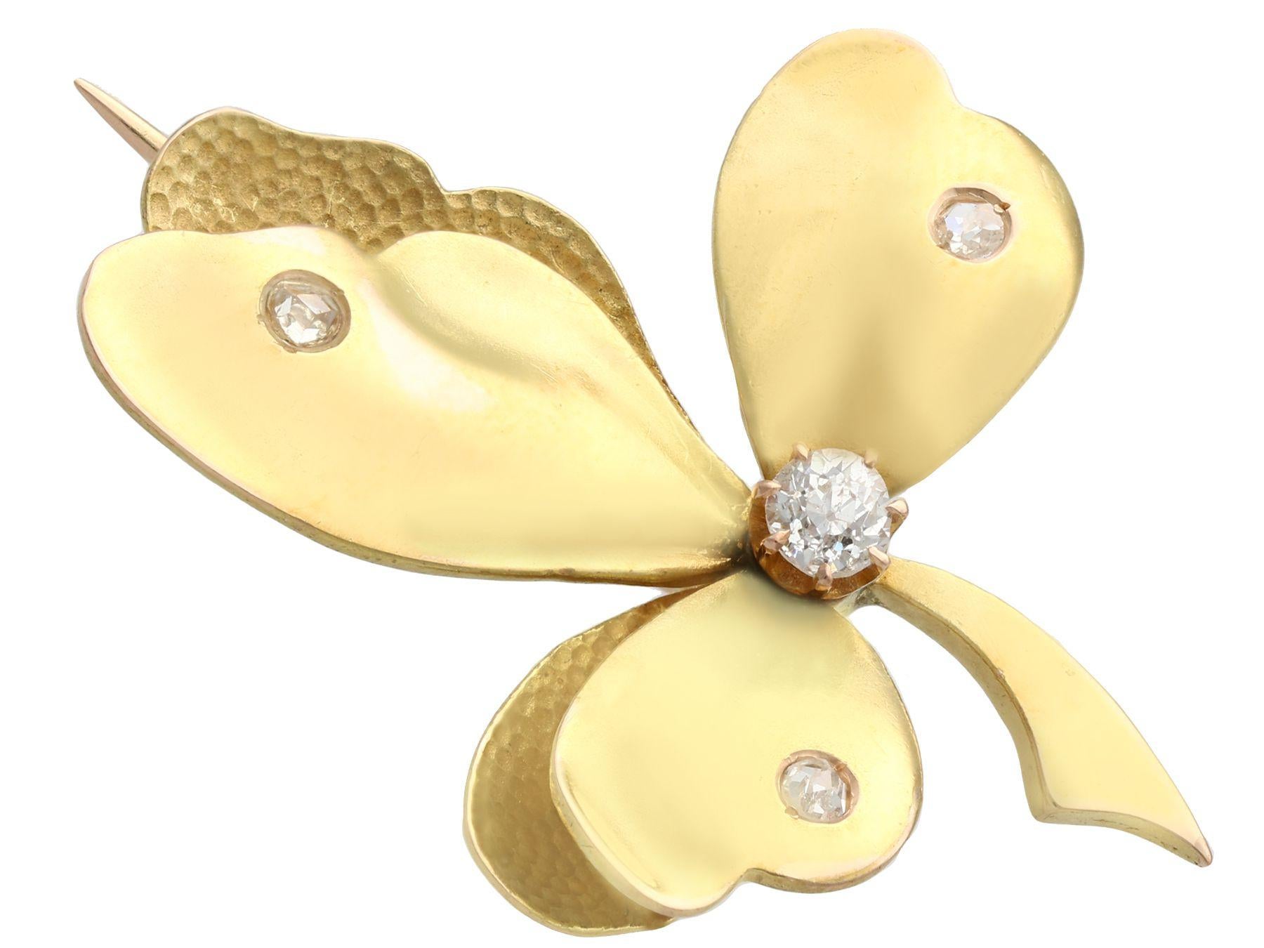 A fine and impressive antique 0.35 carat diamond, 14 karat yellow gold 'leaf' brooch; part of our diverse diamond estate jewelry collections.

This fine and impressive antique gold brooch has been crafted in 14k yellow gold.

The brooch has been