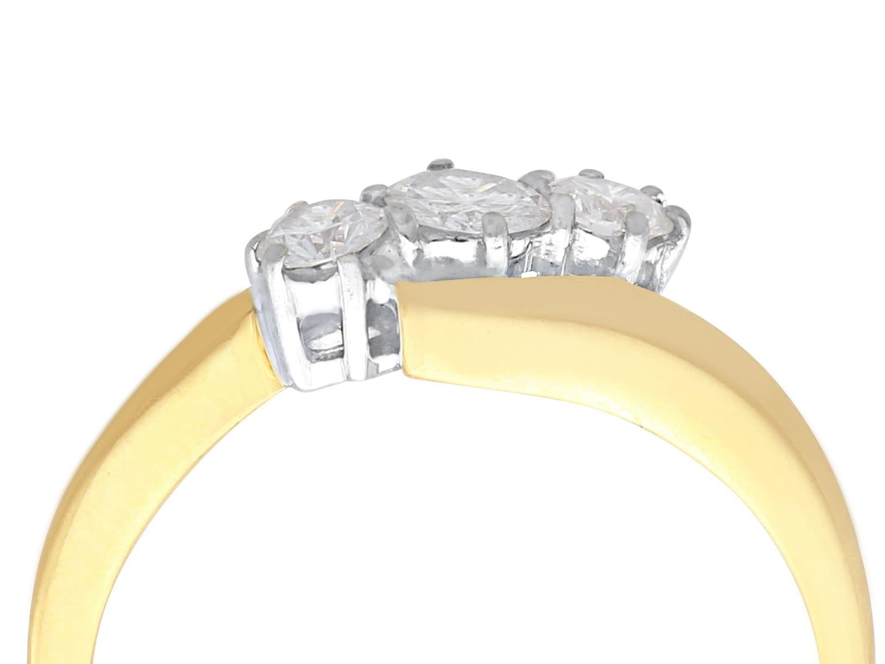 A fine and impressive contemporary 0.46 carat diamond and 18 karat yellow gold, 18 karat white gold set trilogy twist ring; part of our diamond jewelry and estate jewelry collections.

This fine and impressive trilogy twist ring has been crafted in