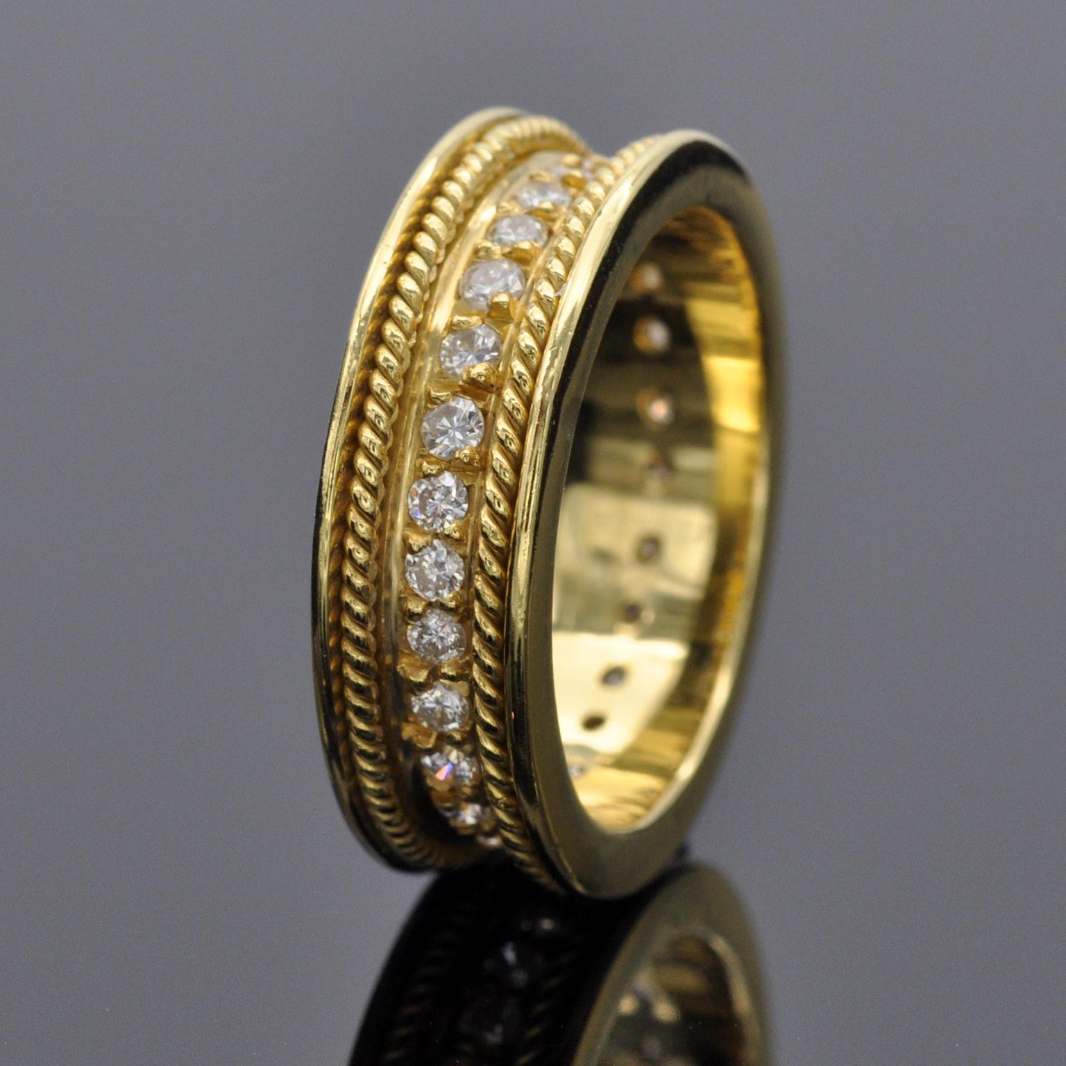 Exquisite handmade eternity ring . The sides of it are very simple and modern shiny yellow gold; in its midst two braided gold wire gives it an antique touch while a line of 27 brilliant cut diamonds enlightens the wedding band and makes it truly