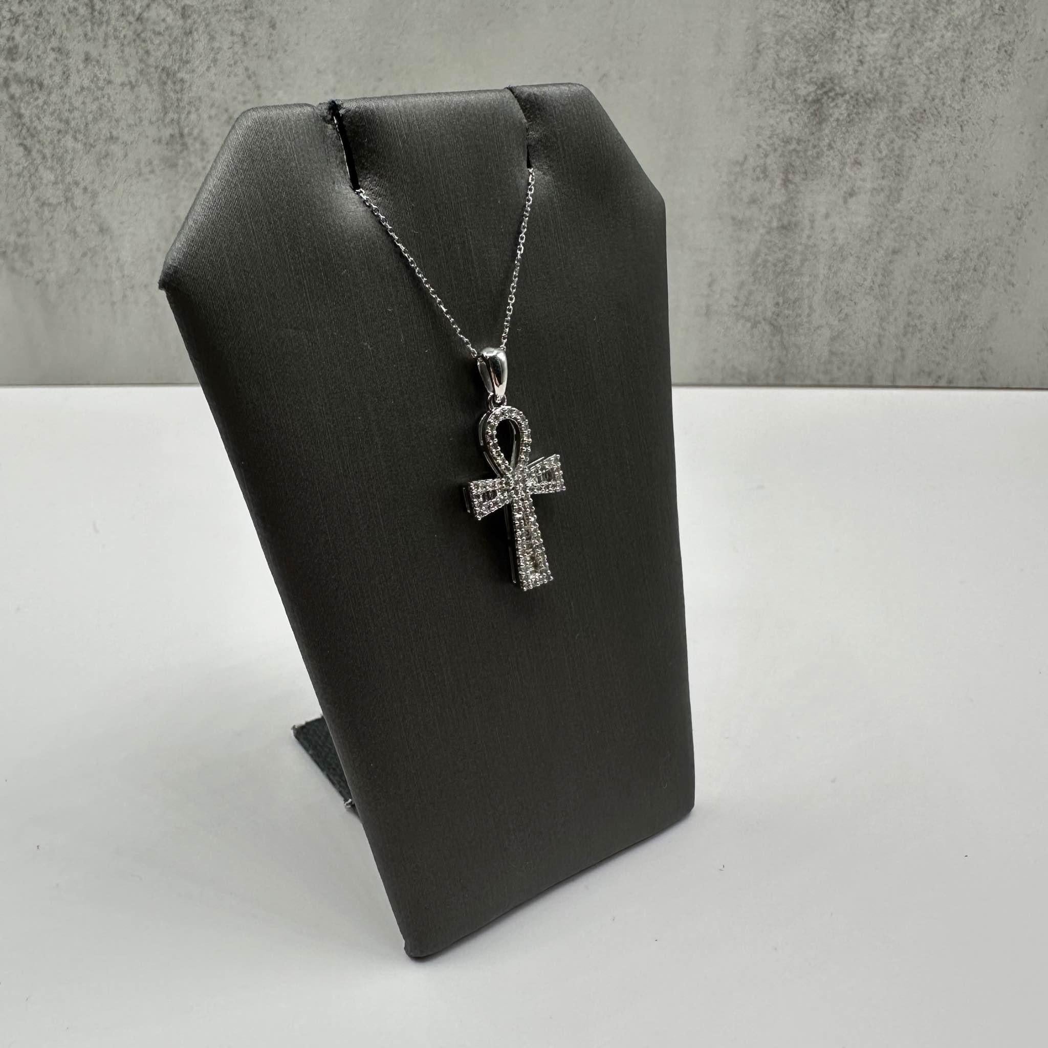 This stunning Diamond Ankh Cross Necklace in 10kt white gold features approximately 0.30ctw of natural HI SI round single-cut and baguette-cut diamonds, adding brilliant sparkle to the unique Ankh cross design. The length is adjustable between 16