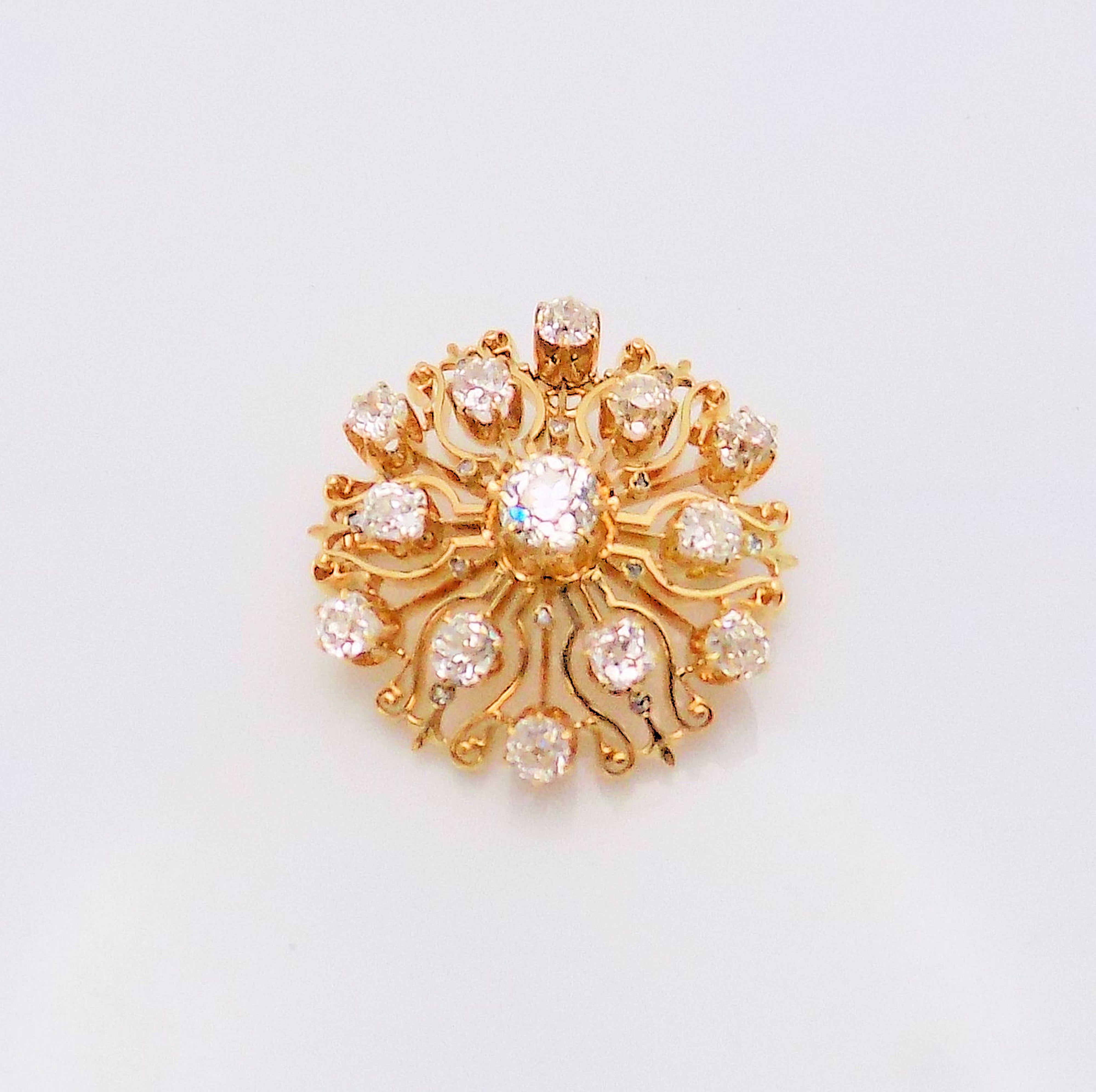 Stunning and Classic is this 18 Karat Yellow Gold Antique Brooch featuring 13 Old Mine Cut Diamonds 3.40 Carat Total Weight, VS-SI, H-I; 1.25 inch diameter; 10.7 DWT or 16.64 Grams.