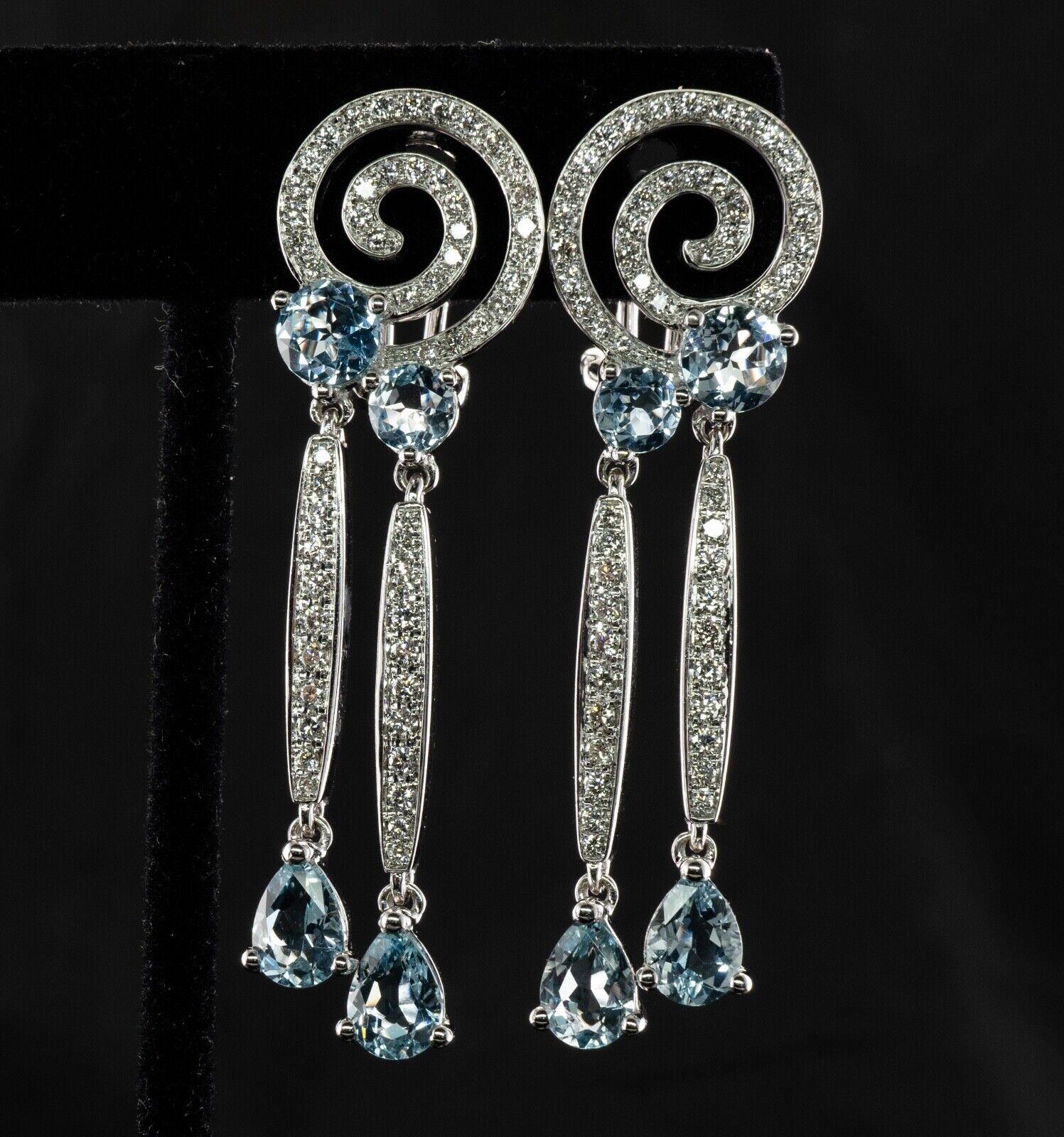 These gorgeous estate earrings are finely crafted in solid 18K White gold and also hallmarked with a symbol we can't recognize. They are set with natural Earth mined Aquamarines and diamonds. Two pear cut aquas in each earring measure 7mm x 5mm, two