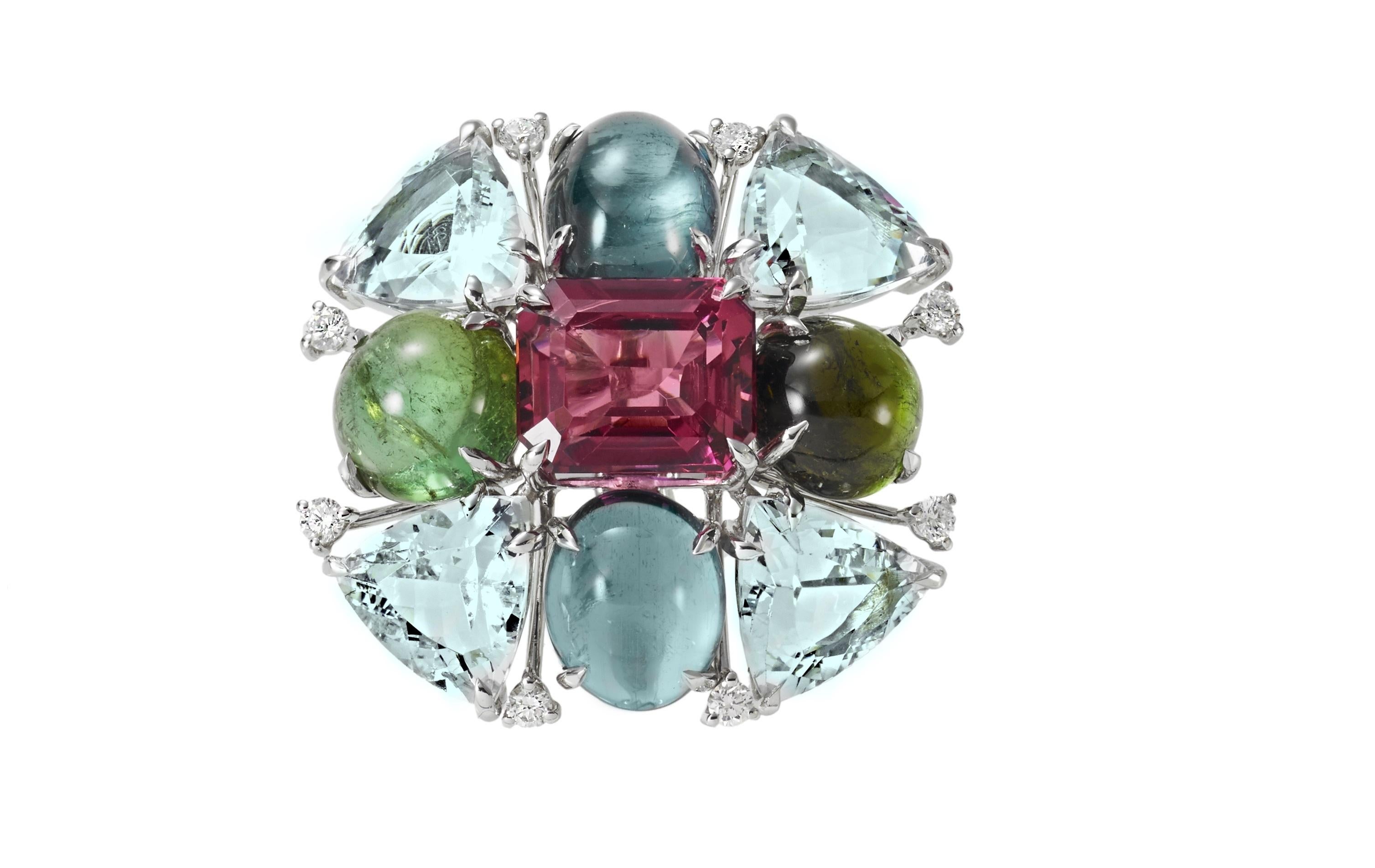 The unique ring is handmade in  18 carat white gold in Margherita Burgener  family workshop based in Italy.

The motif of colored stones is centering  a lovely round cabochon green tourmaline, surrounded by 4 oval faceted intense pink tourmalines,