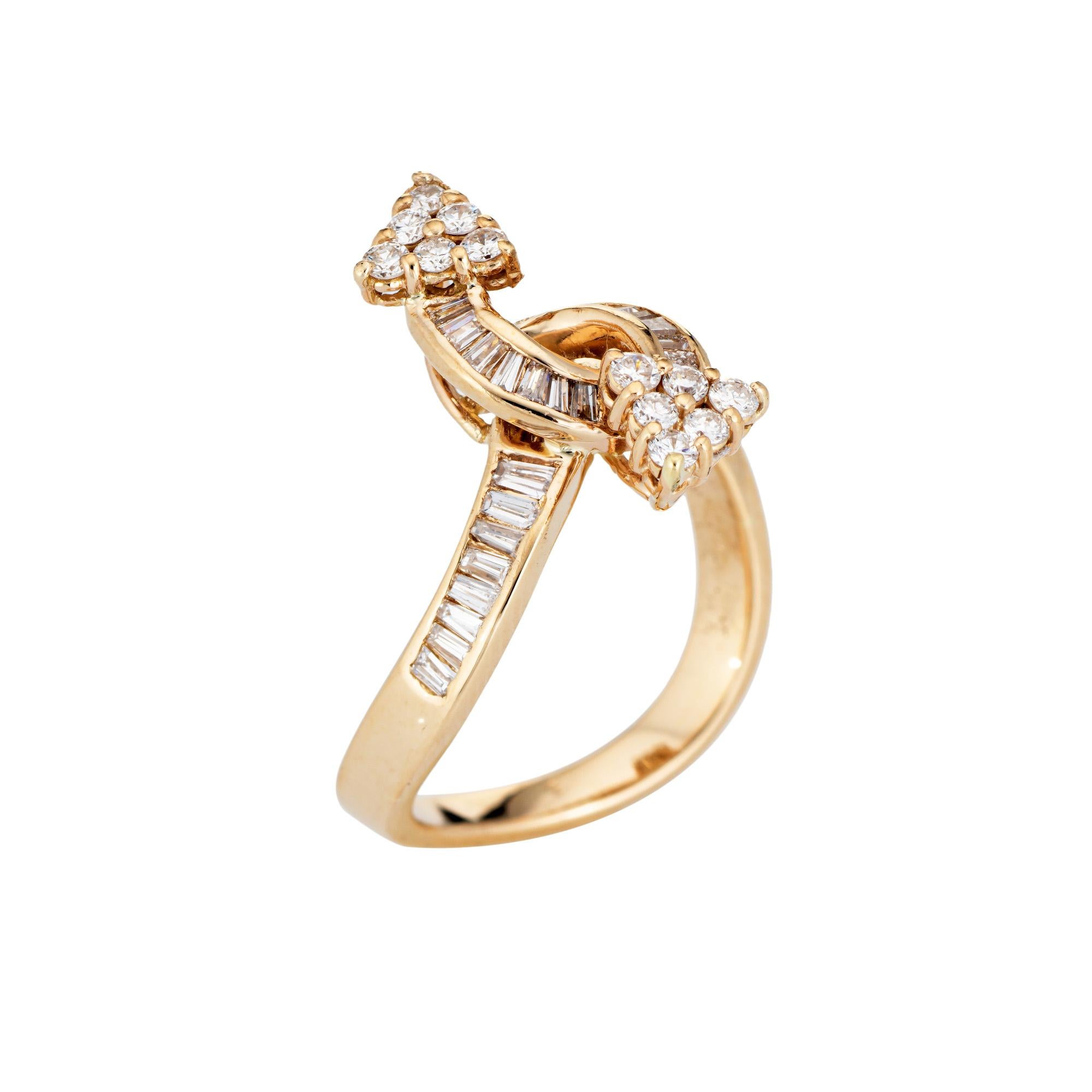 Stylish vintage diamond arrow bypass ring (circa 1990s) crafted in 14 karat yellow gold. 

42 round brilliant and baguette cut diamonds total an estimated 0.84 carats (estimated at I-J color and VS2-I1 clarity). 

Set in opposing design the arrow