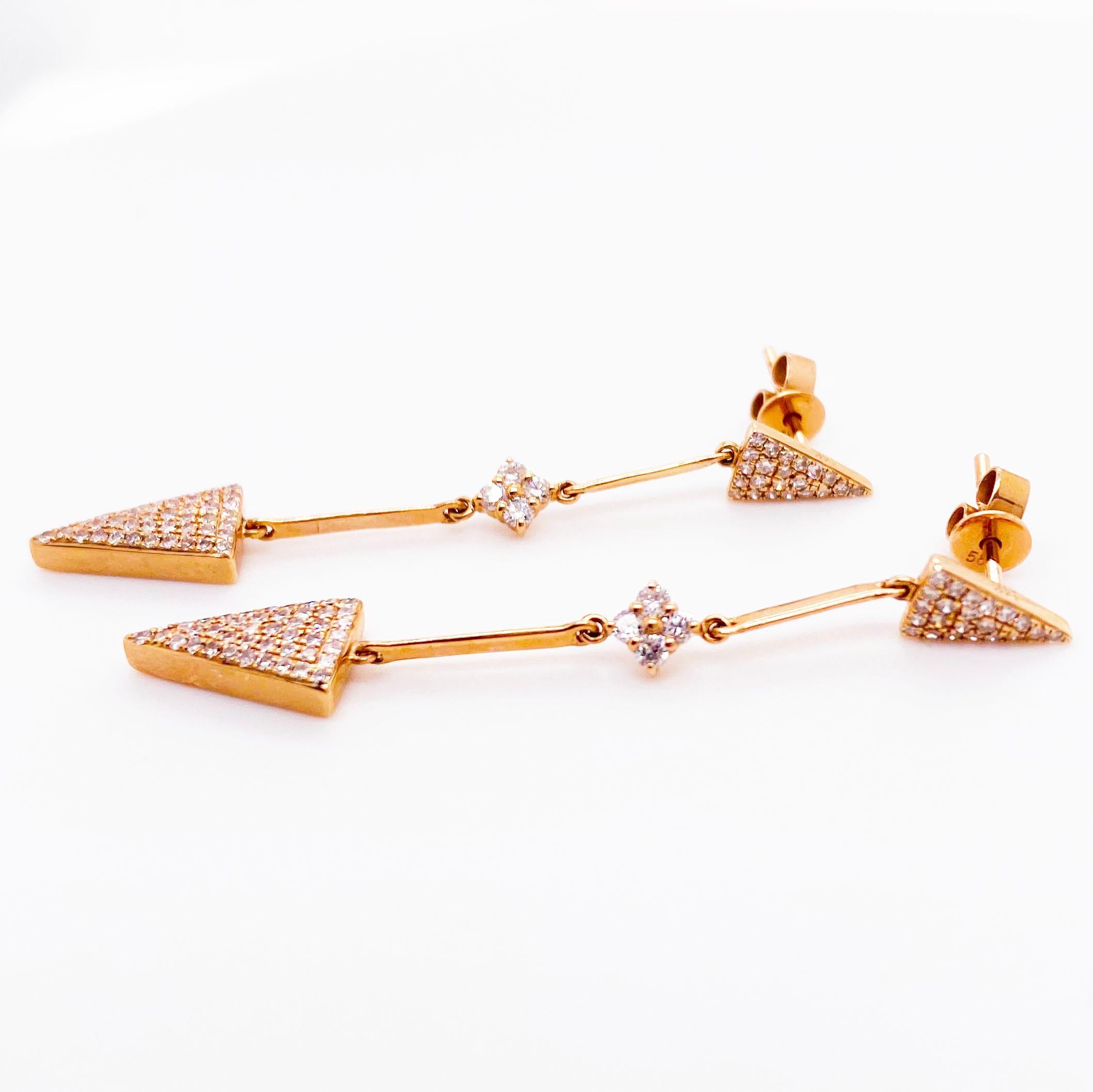 The diamond arrow earring dangles are modern and beautiful! With round brilliant diamonds pave set across the top of two arrow shapes. The earrings are made with separate pieces that are linked together to create a movement that dangles when worn.