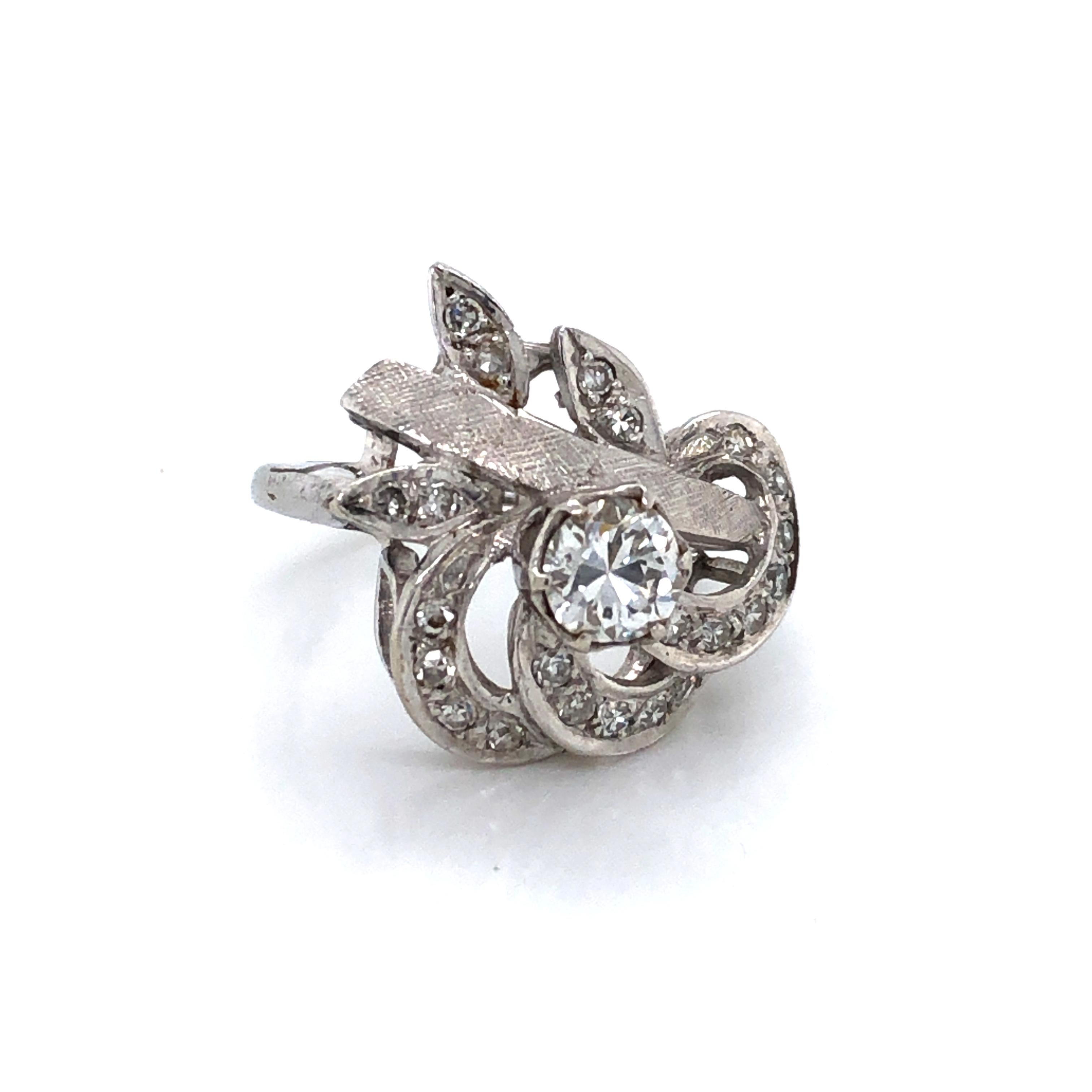 Love the soft curves of this handmade art nouveau floral inspired ring. Crafted with plenty of flair in twelve karat 12k white gold, this ring features one center stone .30 carat H/I3 center miner's cut diamond surrounded by swirling white gold