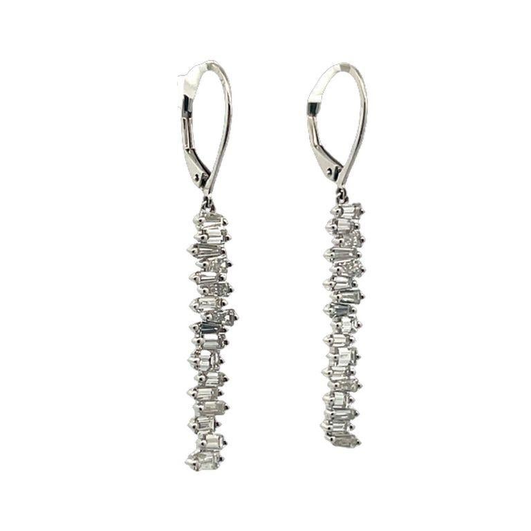 These exquisite drop-down earrings boast a breathtaking arrangement of white baguette diamonds weighing 1.97 carats. They elegantly dangle from the ear, showcasing the diamonds in a unique, modern design that highlights their inherent beauty. The
