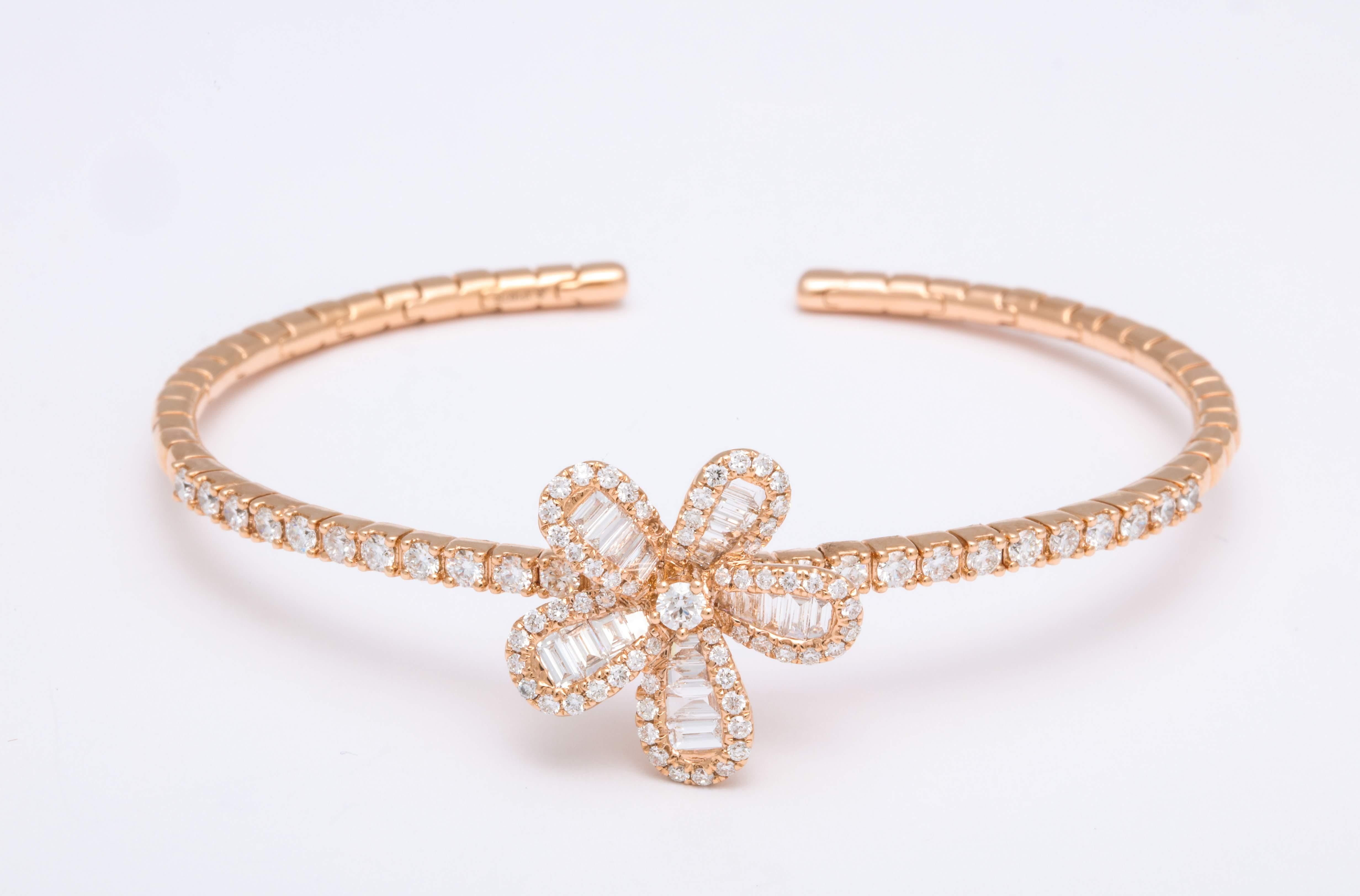 Romantically chic 5-petal floral stationary charm decorated with diamond baguette and brilliant-cut diamond trim, mounted on 18 Karat rose gold clip bracelet finished with pave'-set round brilliant-cut diamonds: 2.11 carats

Dimensions: Inner