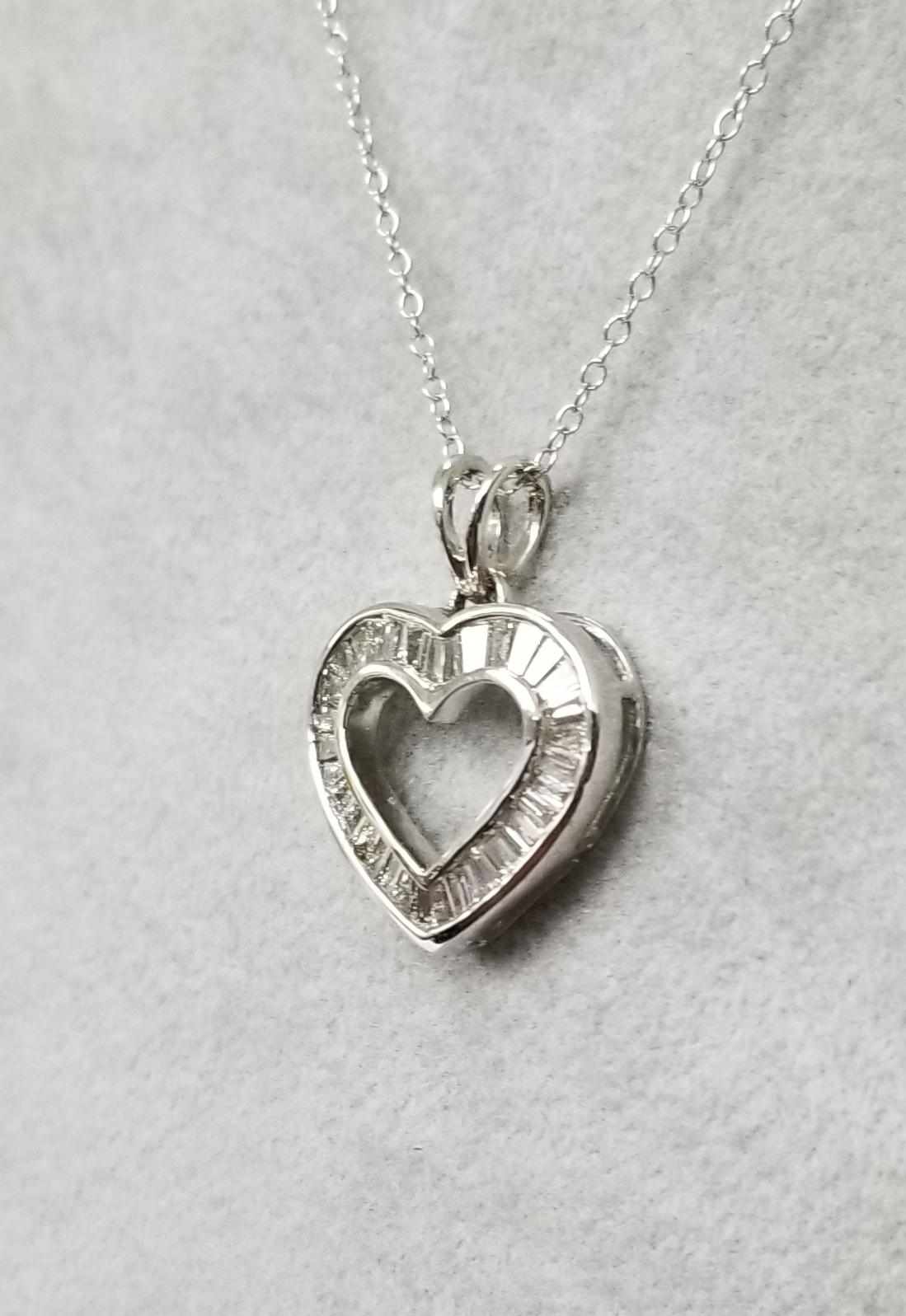 14k white gold diamond heart necklace, containing 35 baguette cut diamonds of very fine quality weighing 1.00cts. on a 16 inch chain.
