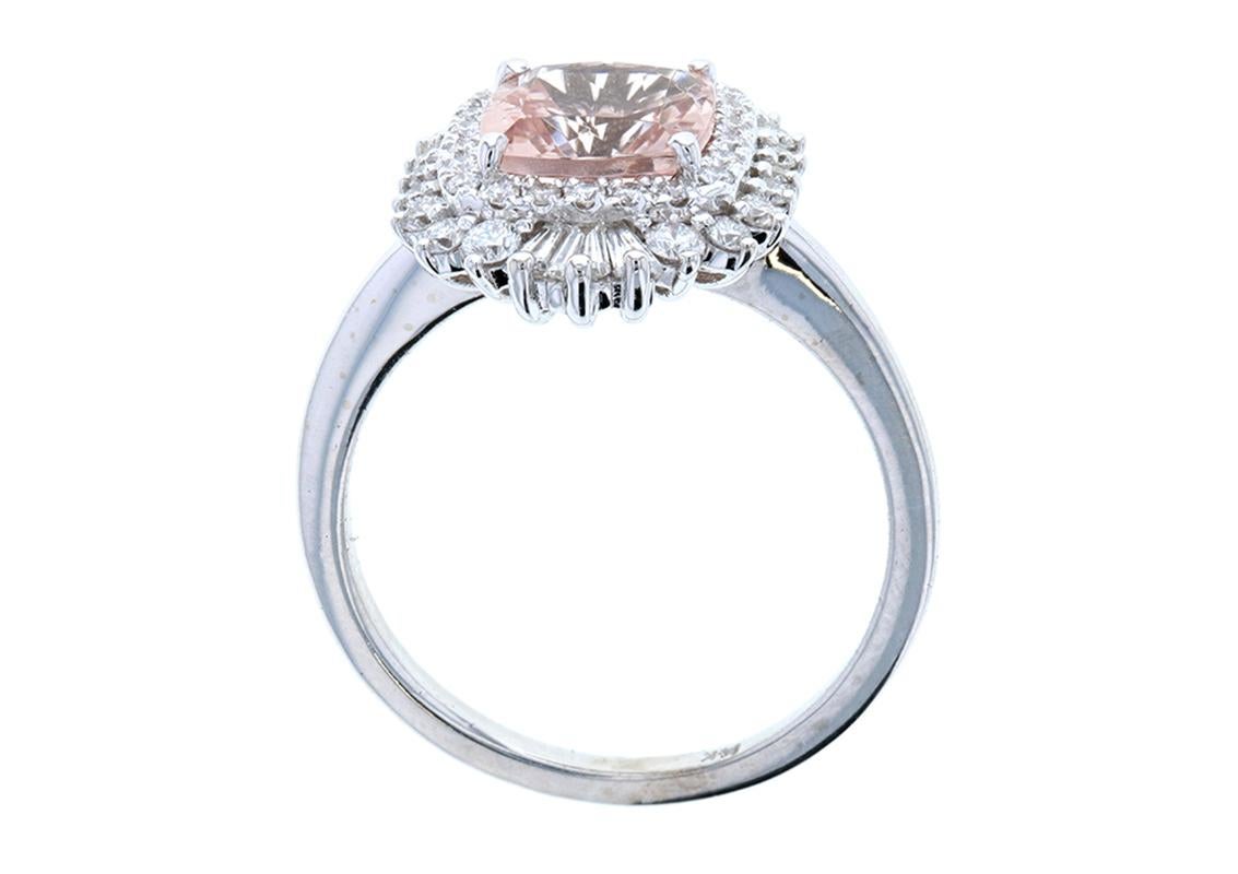 An exquisite Diamond Ballerina Halo Baguette Engagement Ring with a Morganite Center features a burst of custom cut diamond baguettes to enhance and accent the center stone. The Ballerina Halo is a vintage-looking design that is incredibly