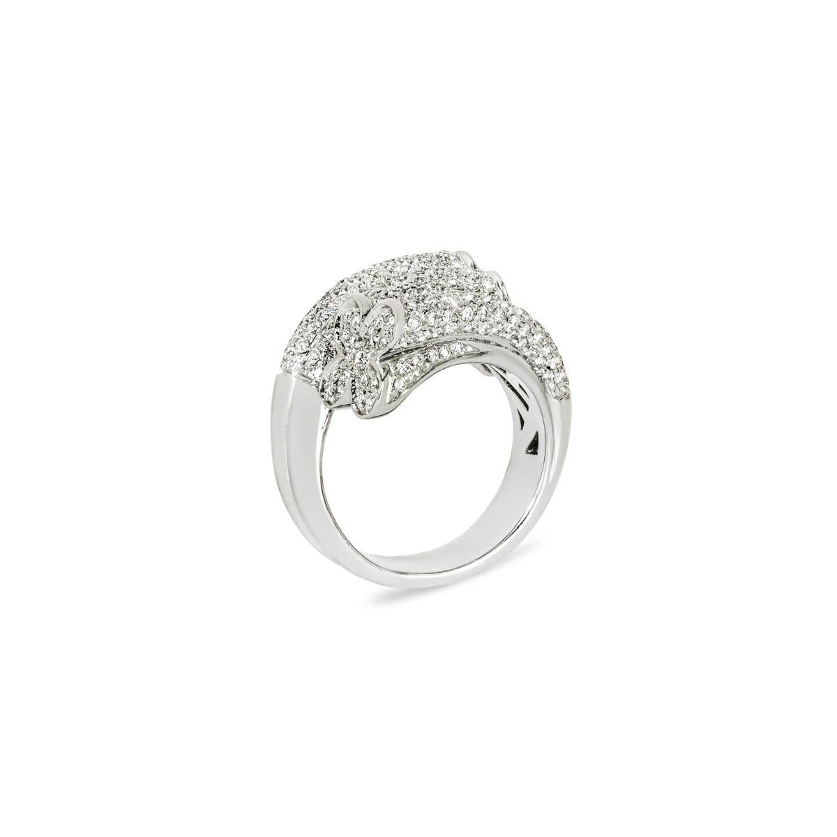 A sparkly 18k white gold diamond dress ring. The bypass style ring features a clover motif at each end and is encrusted with 248 round brilliant cut diamonds with an approximate total weight of 3.22ct, F-G colour and VS clarity. The ring tapers down