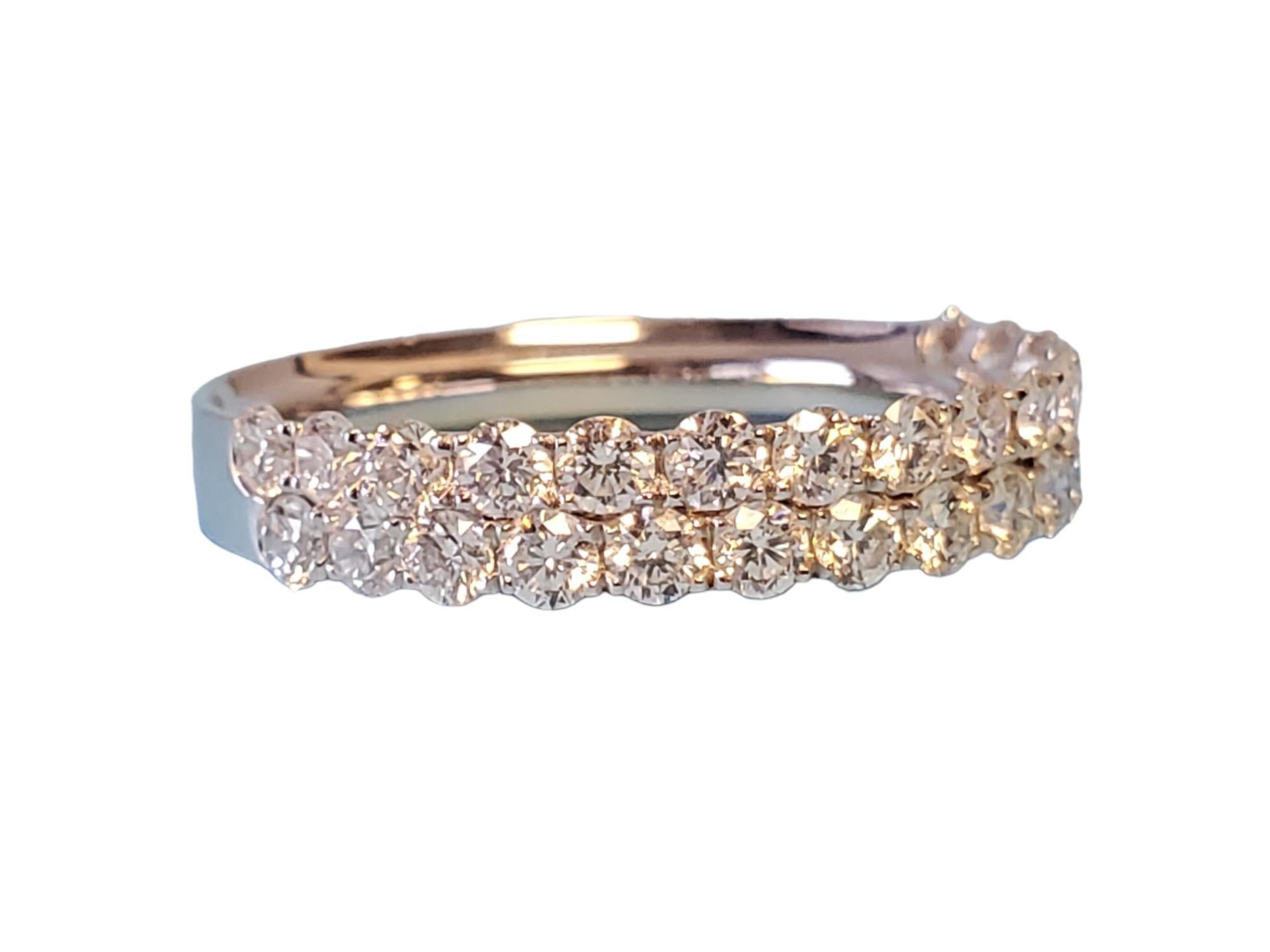 Listed is an 18k white gold closeout diamond band. This ring features 1.2tcw white vs diamond and they are split in 2 rows half way across the ring. Ring size 6.25, this is unworn and ready to be adorned.