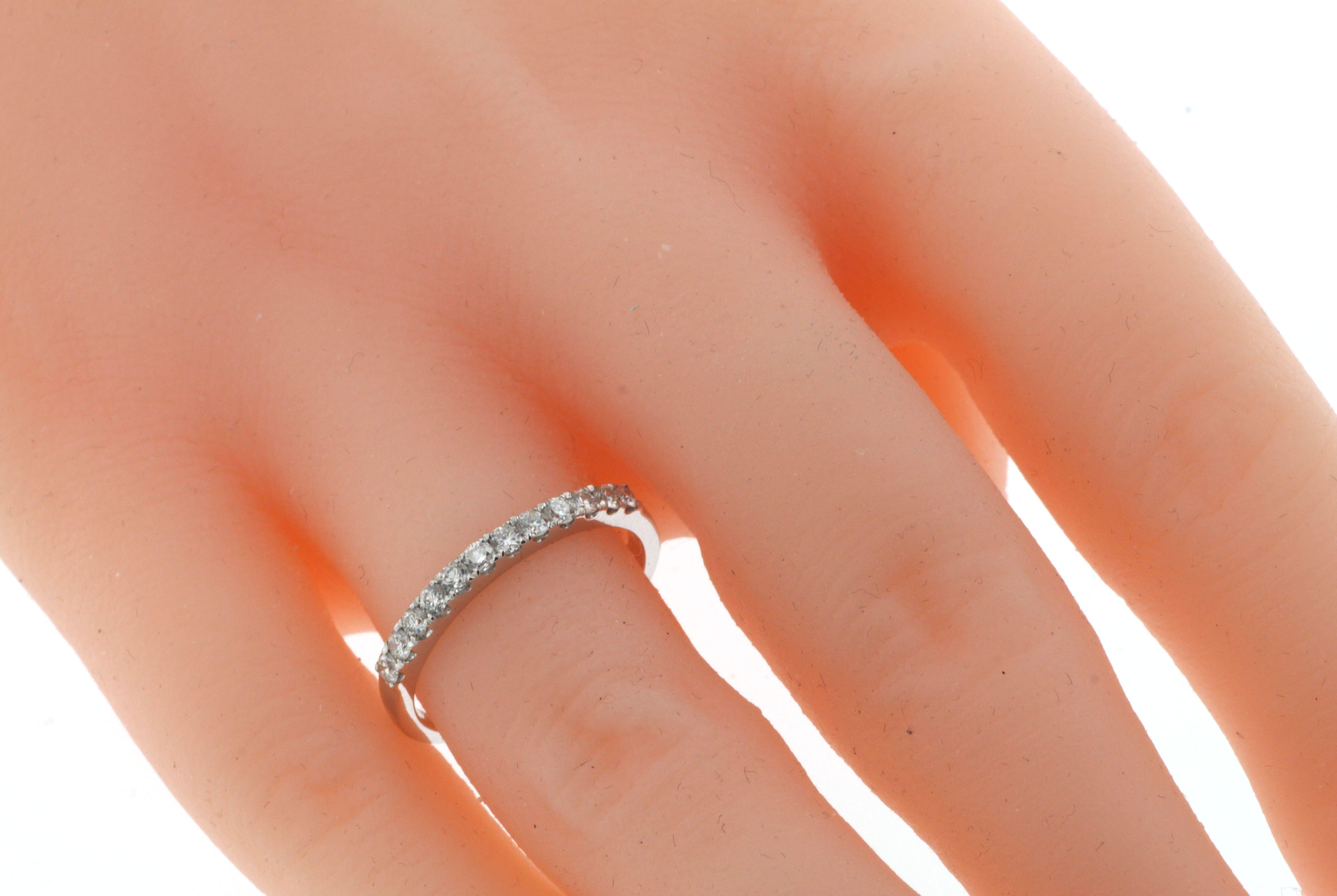 This elegant and understated diamond band ring is crafted in 18 karat white gold and features a total of 0.32 carat of round brilliant cut diamonds. Each diamond weighs approximately 0.026 carat, offering a delicate yet radiant sparkle perfect for