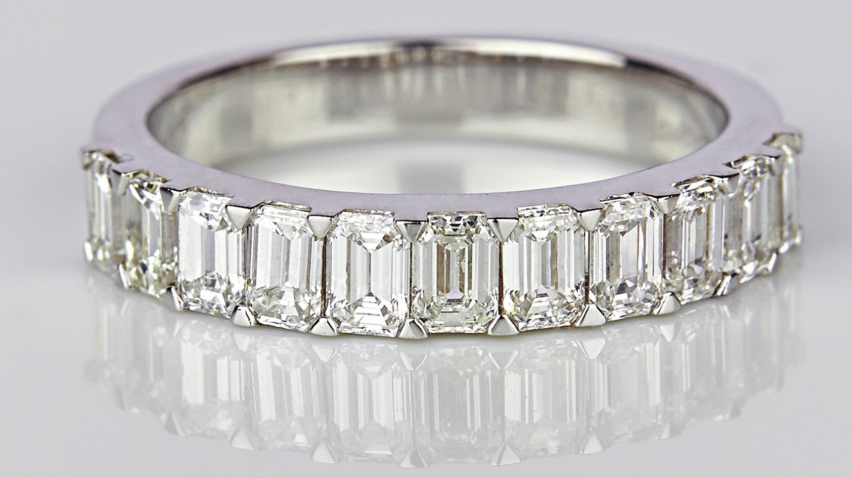 A Classic Diamond band set in 4.36 grams of 18K White Gold with 11 Emerald cut diamonds studded around in SI/GH quality and color weighing 1.47 carats. 

These diamonds have been carefully picked and selected from authentic sources and complete