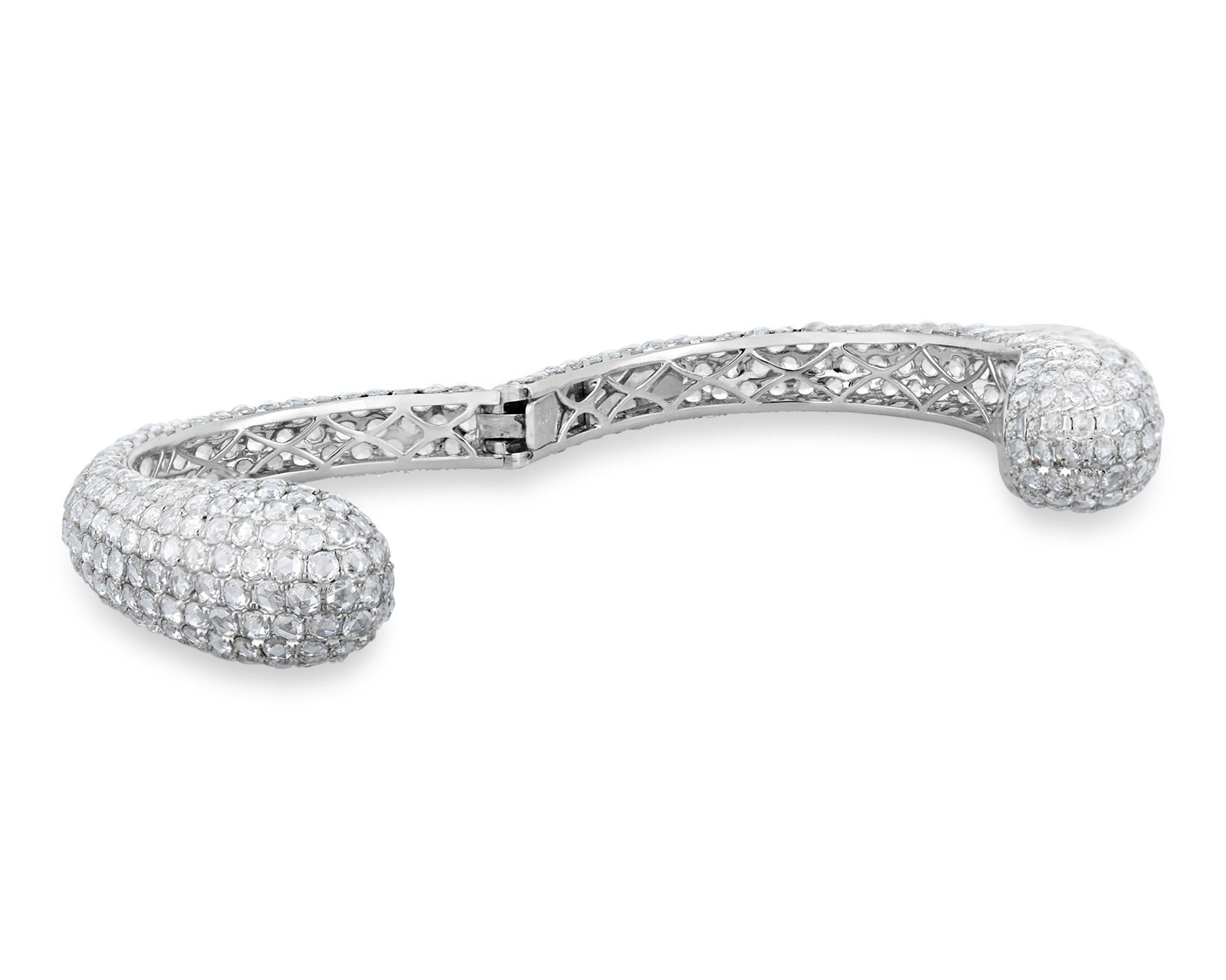 This elegant and dazzling bangle bracelet features approximately 21.97 carats of pavé-set rose-cut diamonds. The bangle shines in 18K white gold.