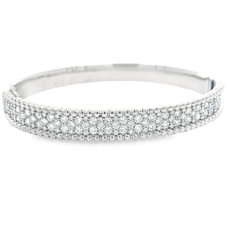 We are thrilled to introduce you to our stunning Sparkle Diamond Bangle! This exquisite piece has been crafted with the utmost care and attention to detail, featuring two rows of shimmering round diamonds arranged in a captivating design at the