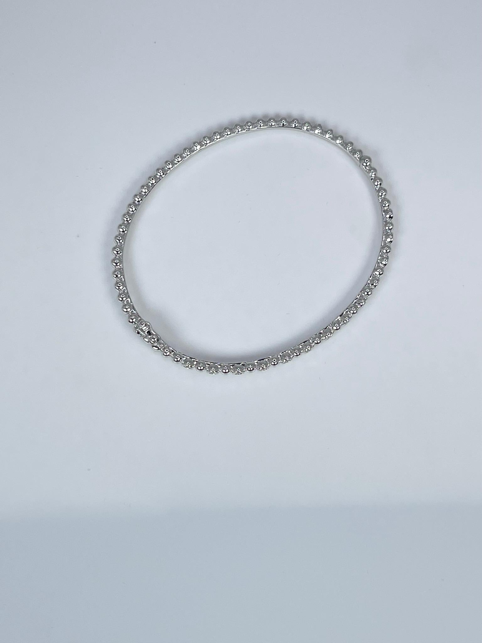 Unique Diamond Bead Bangle Bracelet in 14KT white gold.

GRAM WEIGHT: 9.60gr
GOLD: 14KT white gold

NATURAL DIAMOND(S)
Cut: Round Brilliant
Color: F (average)
Clarity: VS (averge)
Carat: 0.38ct
Diameter:66mm x 53mm 

WHAT YOU GET AT STAMPAR