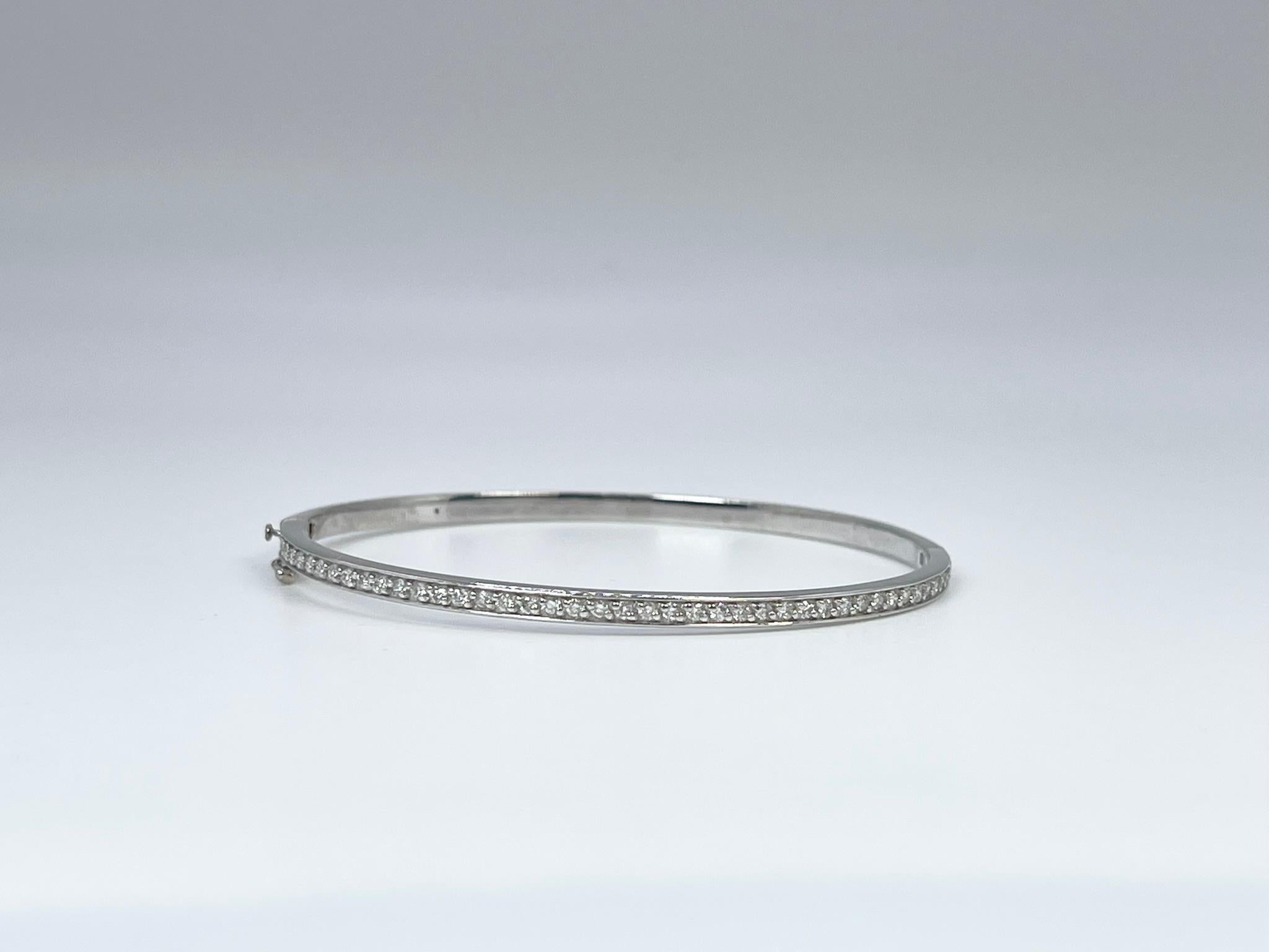 Diamond Bangle bracelet in 14KT white gold.

GRAM WEIGHT: 9.42gr
METAL: 14KT WHITE gold

NATURAL DIAMOND(S)
Cut: Round 
Color: G (average)
Clarity: VS-SI (average)
Carat: 0.45ct
Length: 2.1 inches long by 1.9 inches wide
Item number: 170-00008