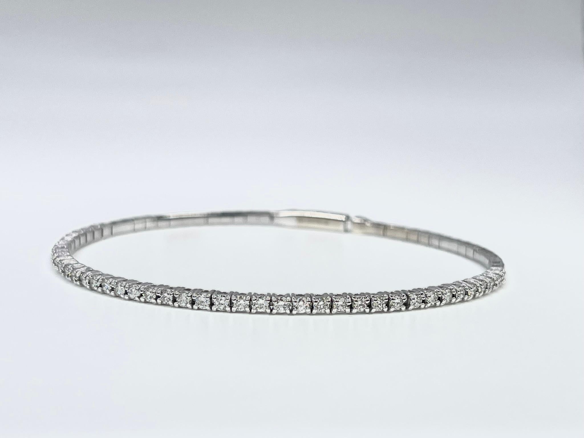 Diamond Bangle bracelet in 14KT white gold, the bangle bracelet is flexible and very comfortable when on the hand.

GRAM WEIGHT: 6.00gr
METAL: 14KT white gold

NATURAL DIAMOND(S)
Cut: Round Brilliant
Color: F-G 
Clarity: VS-SI 
Carat: 0.97ct
Length: