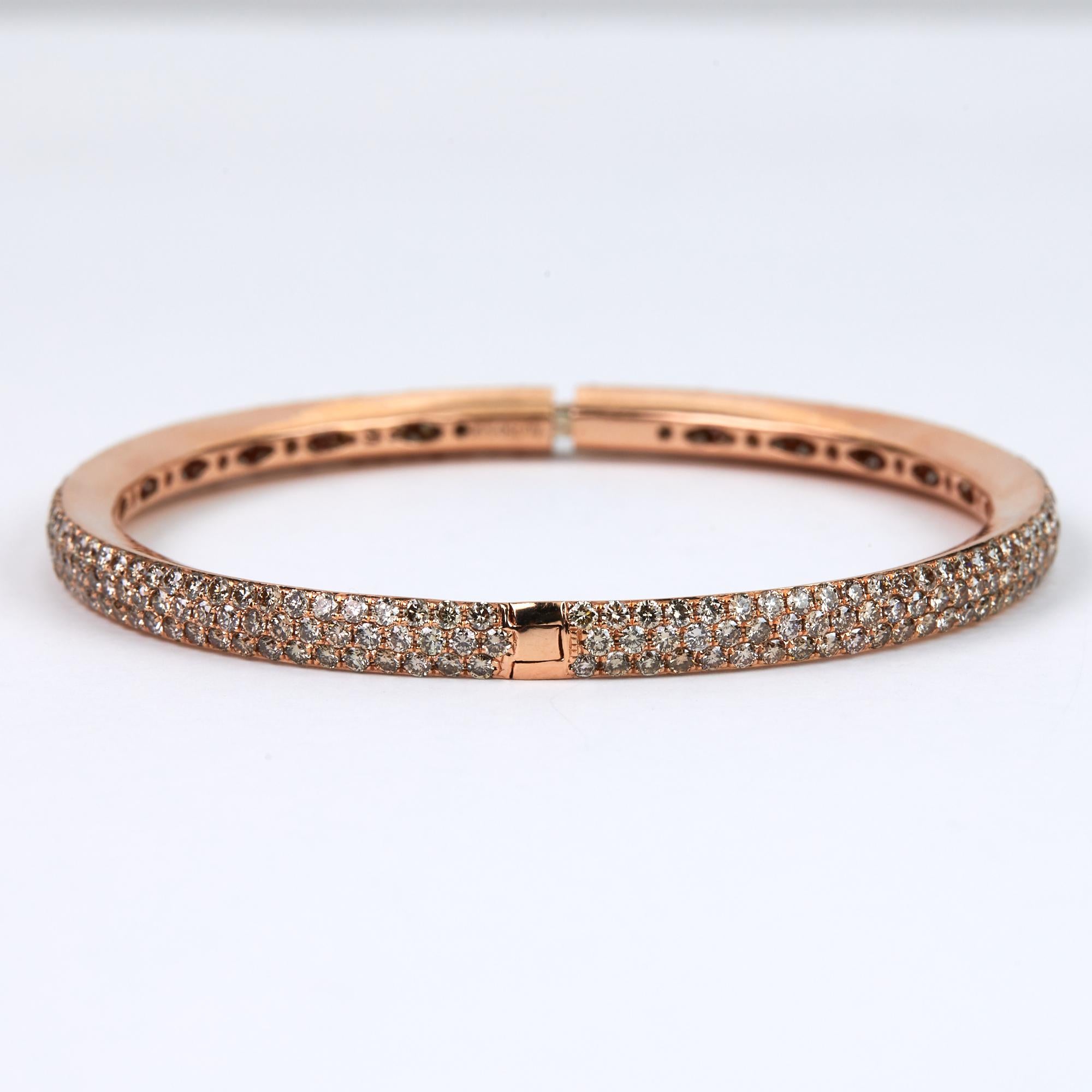 Diamond Bangle Bracelet with 5.96 carats of brilliant round cut fancy brown diamonds.  This beautiful modern bracelet is hand made for us in Honk Kong.  Pavé set diamonds set in 18 karat rose gold in an eternity style bracelet.  Hinged for easy on