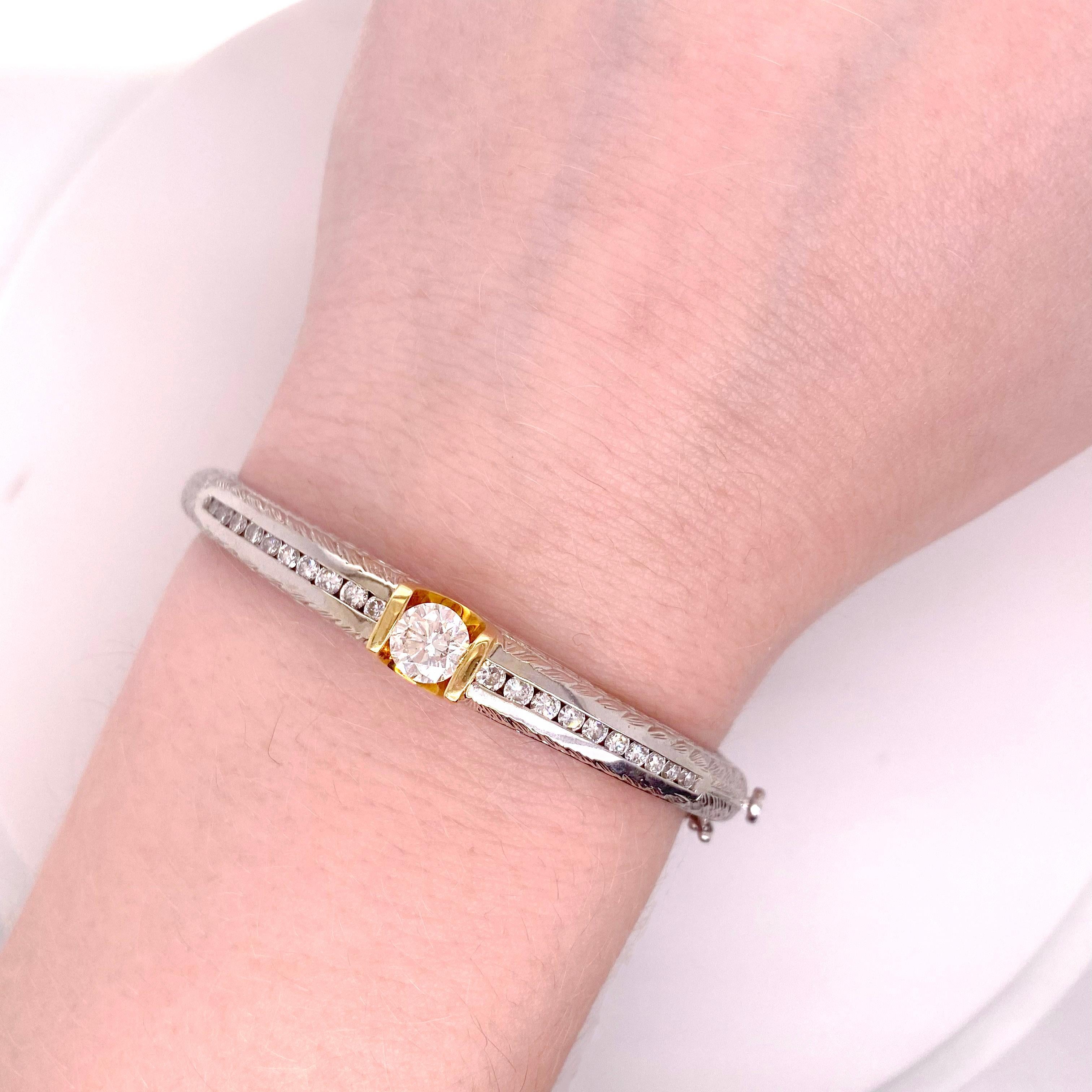 This bangle bracelet has one larger gorgeous diamond set in 14 karat yellow gold and then there are 20 diamonds that are channel set going do the center of the bracelet.  This bracelet is heavy and will never bend or dent as it is solid and not