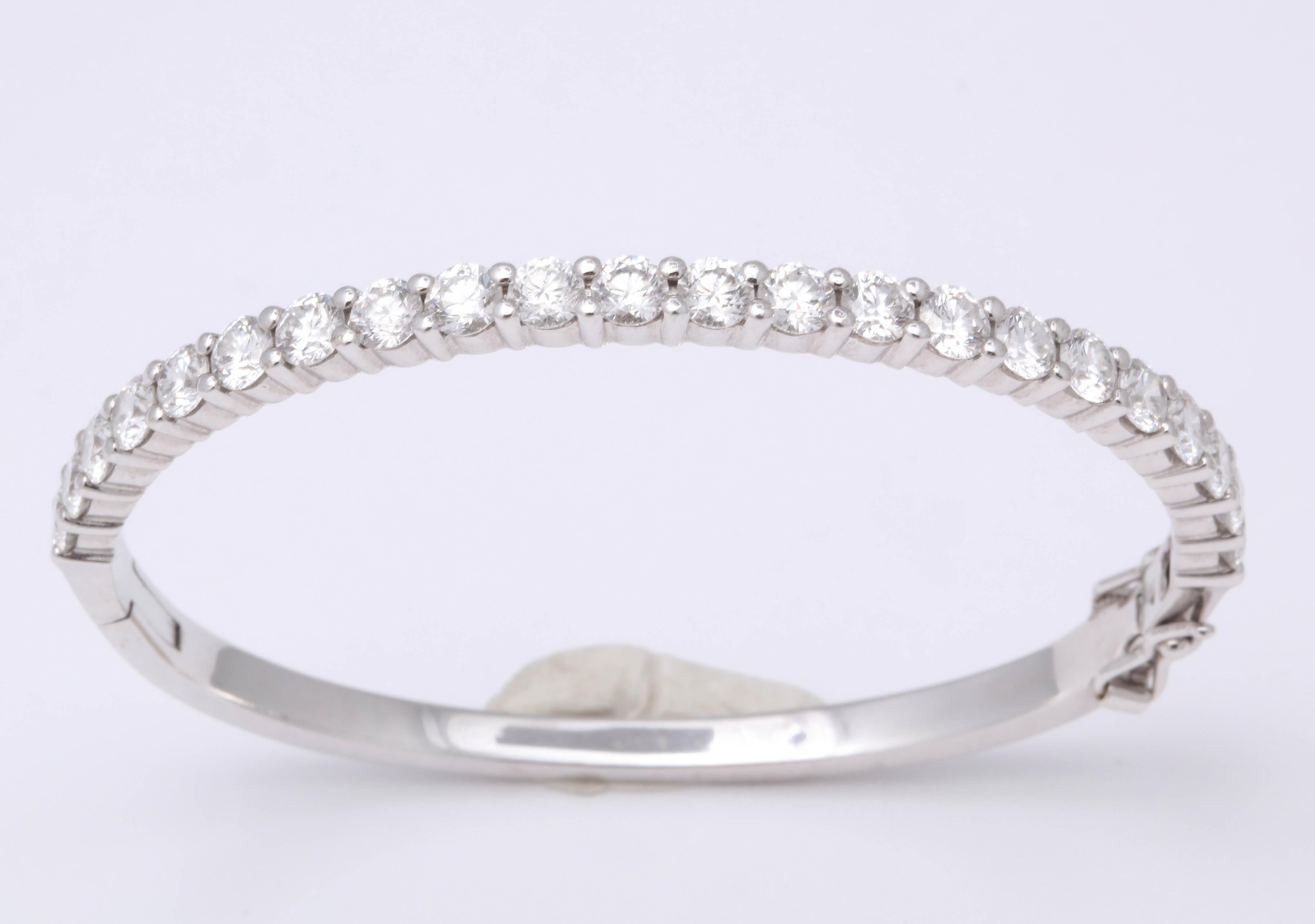 
An incredible diamond bangle!!

4.30 carats of white round brilliant cut diamonds set in white gold.

The diamonds are full of fire -- very brilliant. 

A gorgeous (and very wearable) bangle bracelet.

Makes a statement on its own but is also
