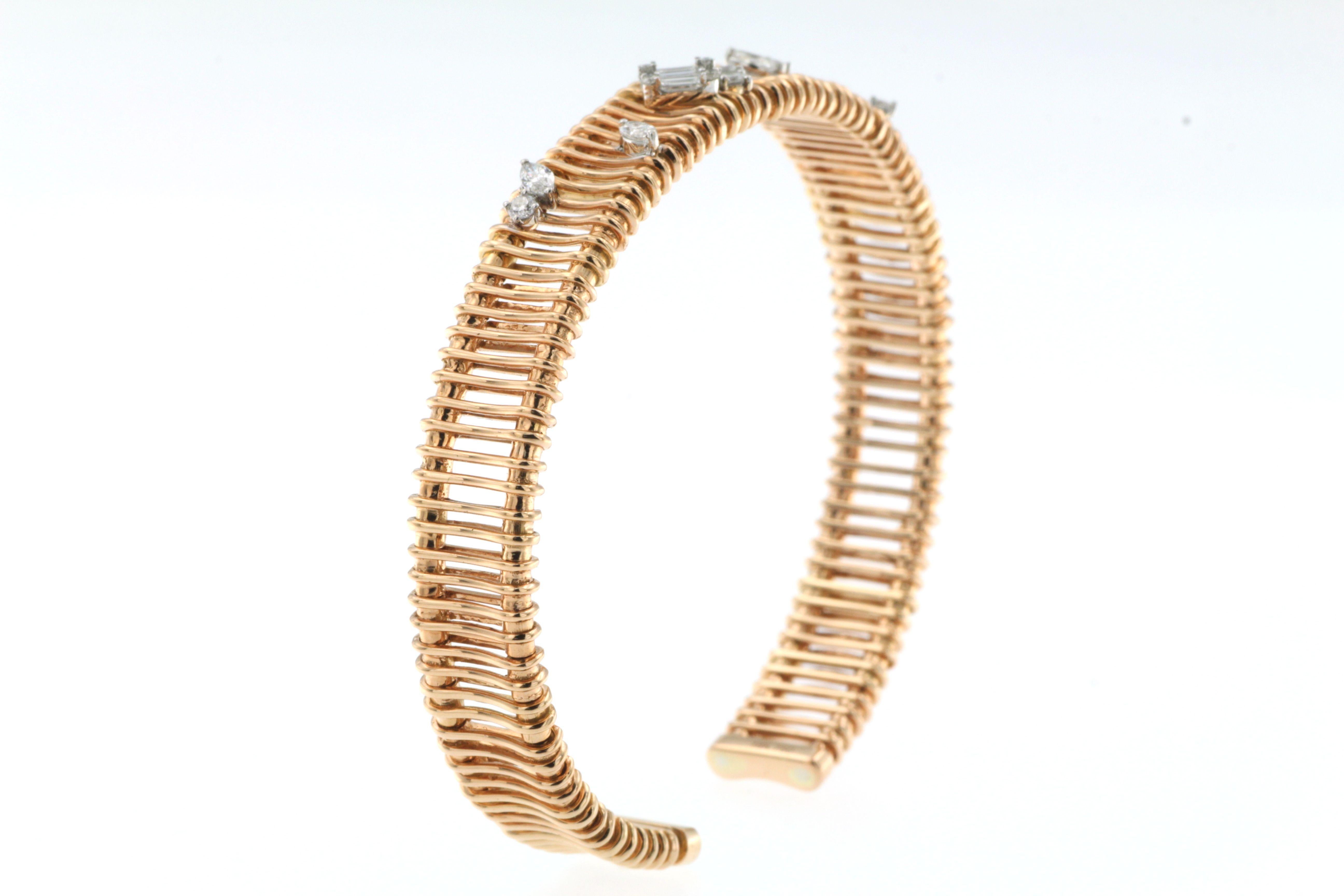 The bangle presented in the image is a beautiful piece of jewelry, crafted from 18 karat rose gold, and adorned with 0.47 carats of diamonds. The design features a flexible, slinky style, which gives it a modern and luxurious feel. The rose gold