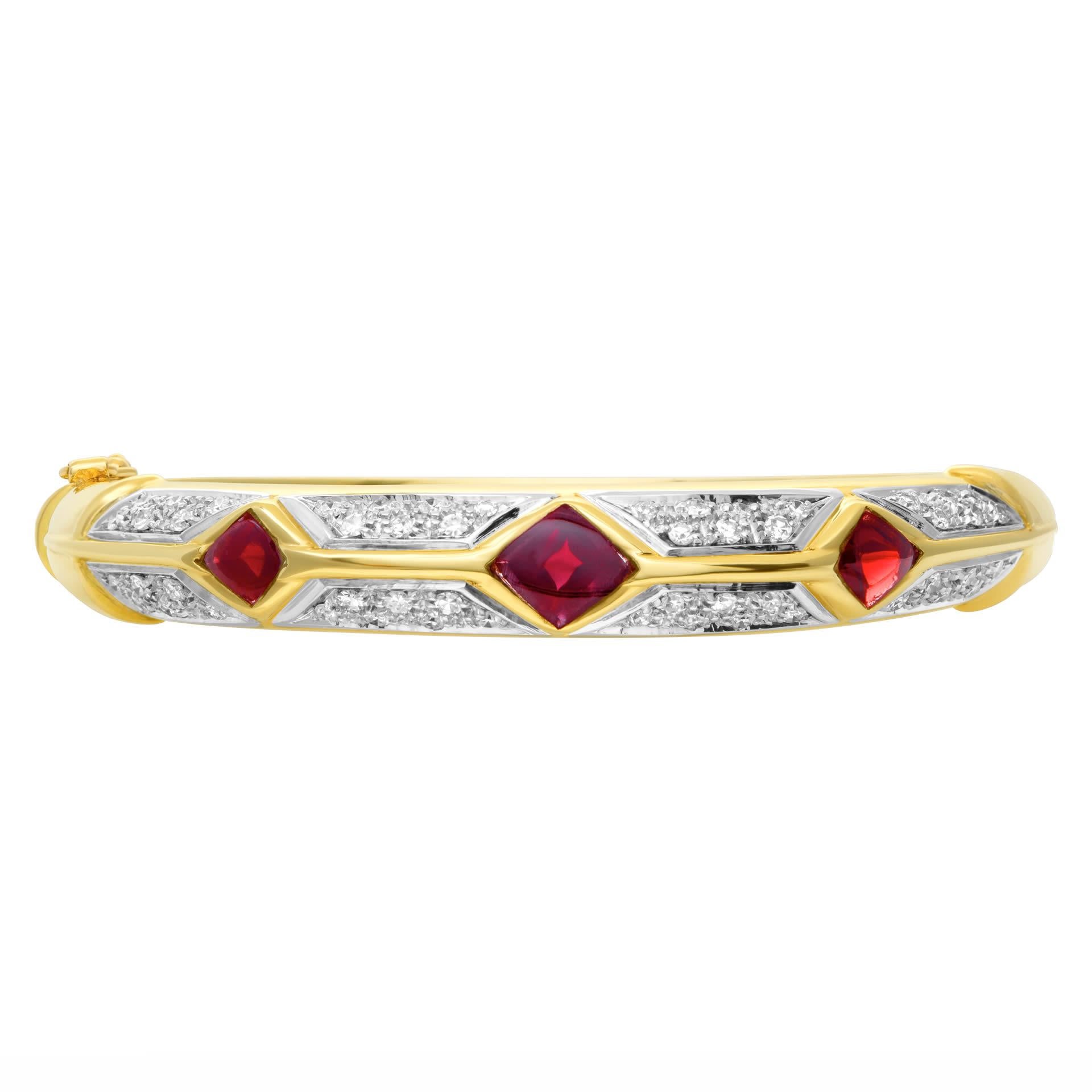 Garnet and diamond bangle in 18k white and yellow gold with 1 carat in round brilliant cut G-H color, VS clarity diamonds. Bangle is approximately 9.6mm wide. Fits 6.5-7in wrist.
