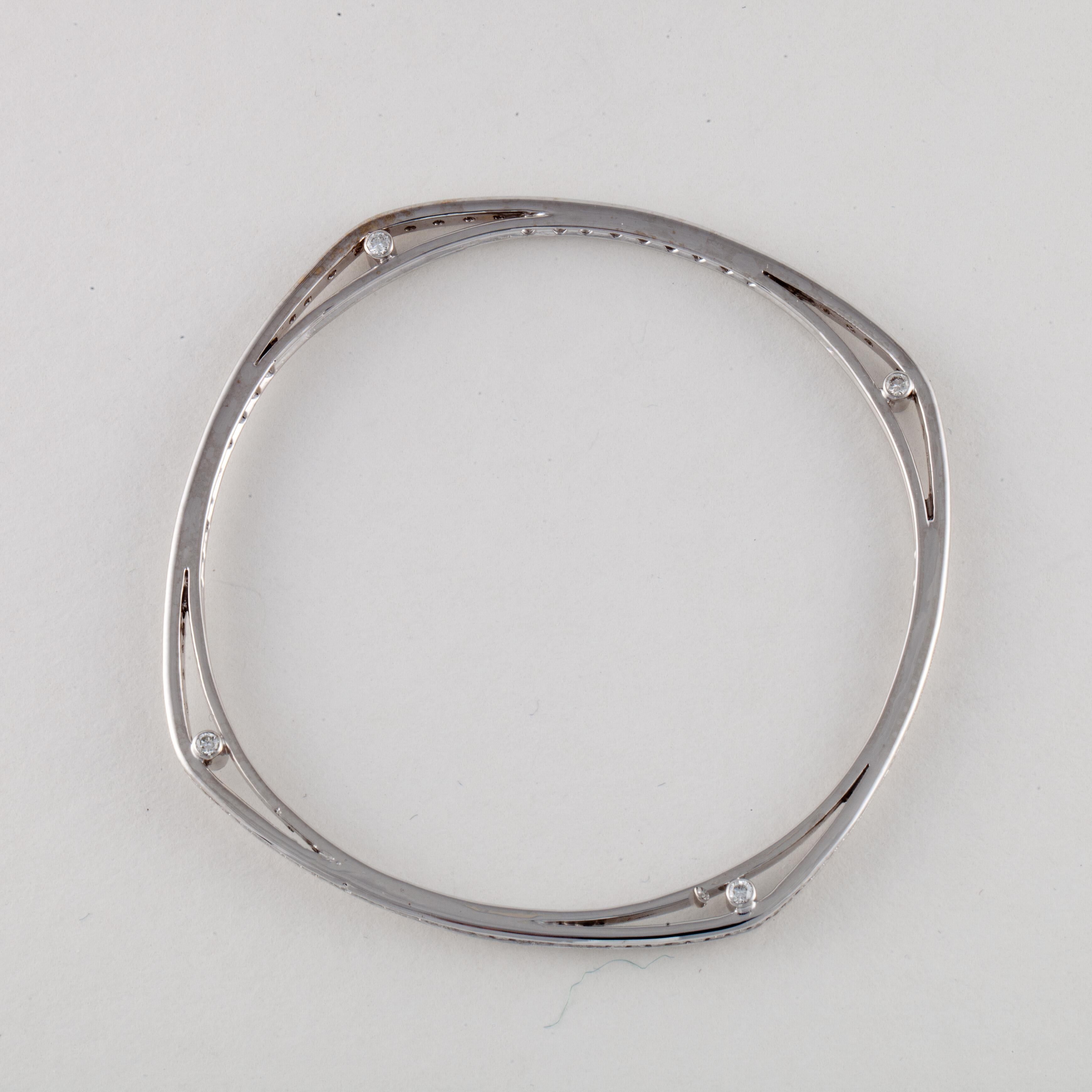 18K white gold diamond bangle in a rounded square shape.  There are diamonds at each corner on both sides as well as around the circumference.  It has 136 round diamonds that total 2.90 carats, G-H color and VS1-VS2 clarity.  The bracelet measures