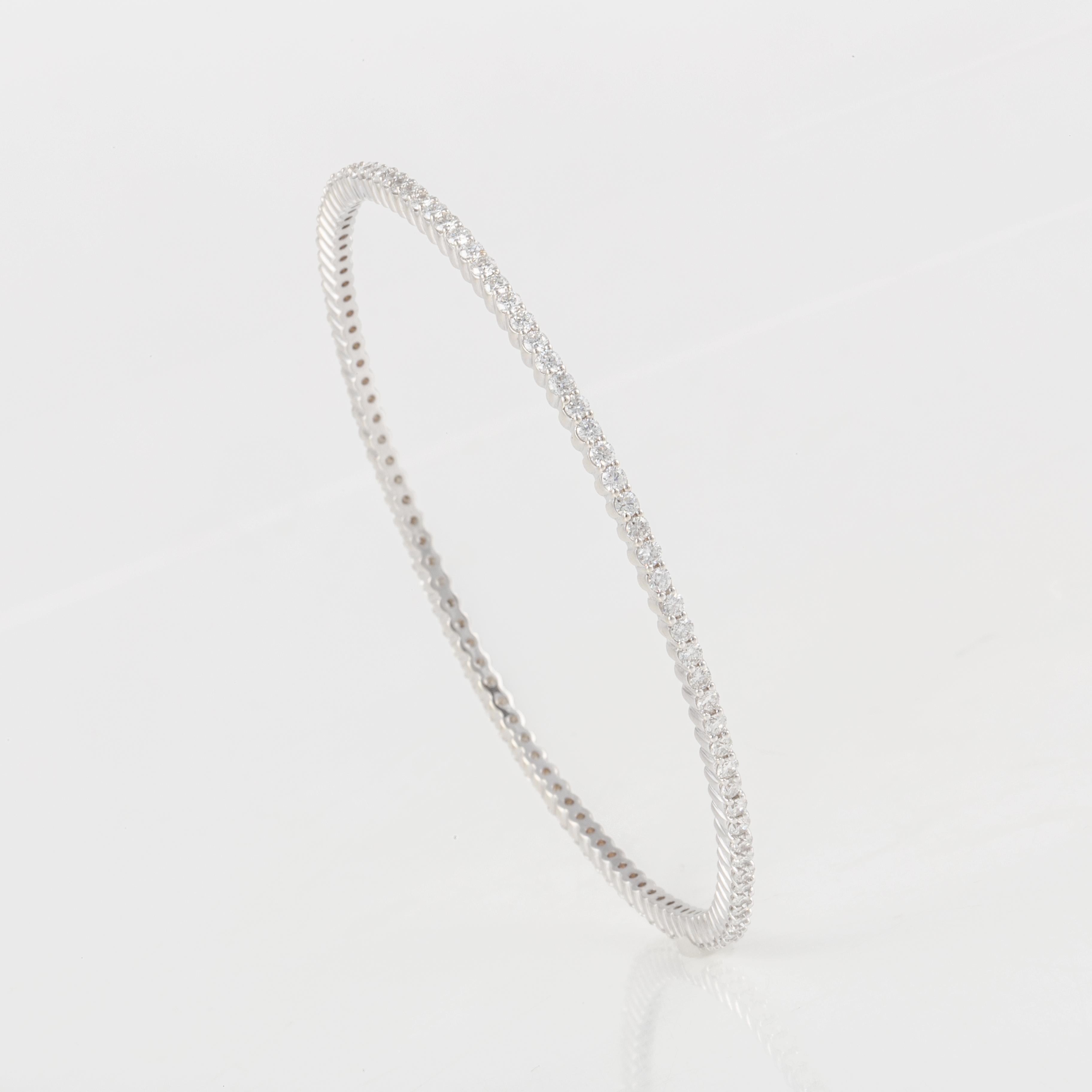 18K white gold slip on bangle bracelet with round diamonds going all the way around.  There are a total of 104 diamonds that total 3.15 carats; H-I color and SI clarity. The measurements from the inside are 2 1/2 inches in diameter and the bangle is
