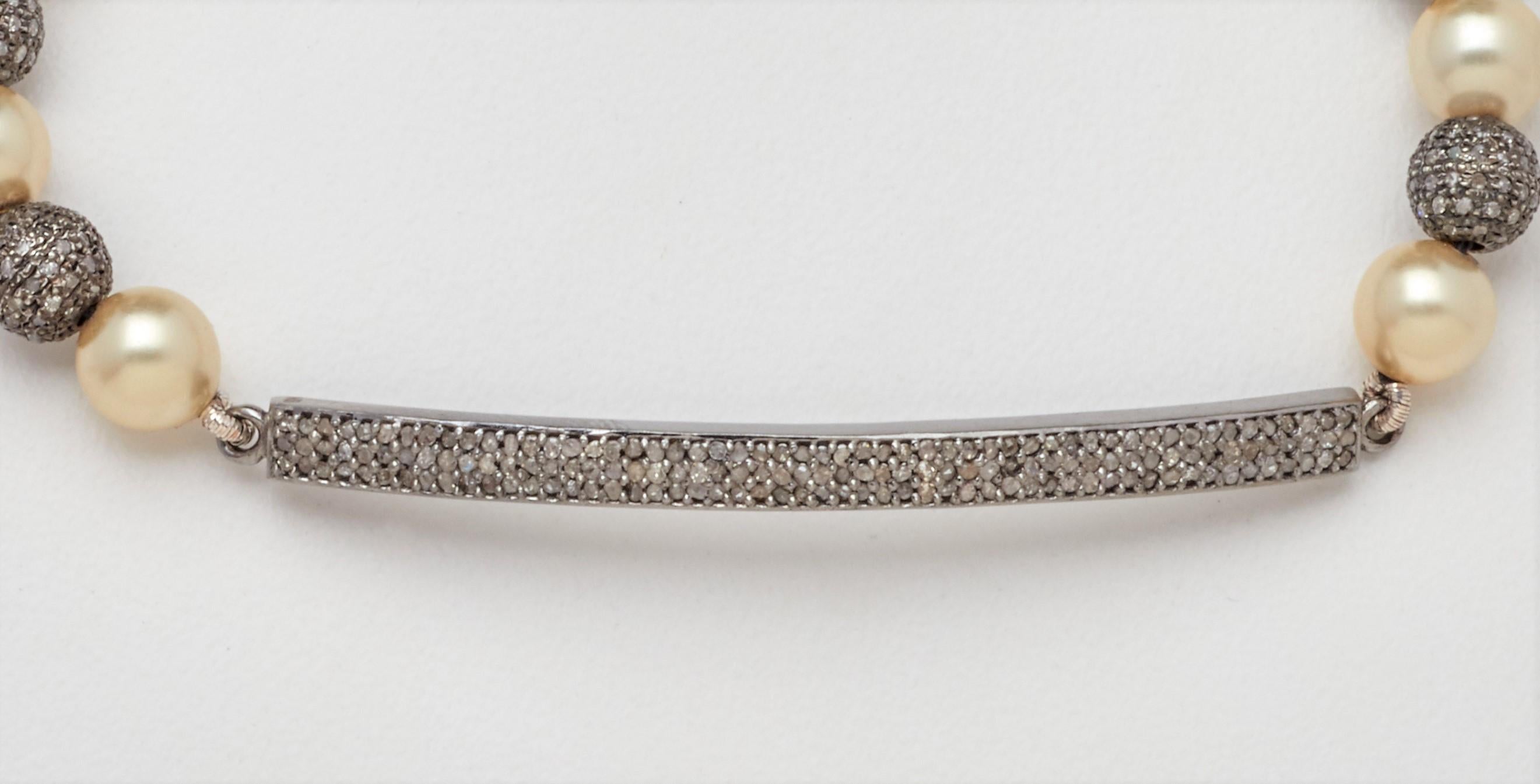 A slender genuine diamond bar gives a modern twist to this new artisan sterling silver bracelet design with alternating creamy lustrous Akoya Pearls intermingled with diamond pave oxidized silver beads. Measuring 7-1/4 inches, this hand crafted