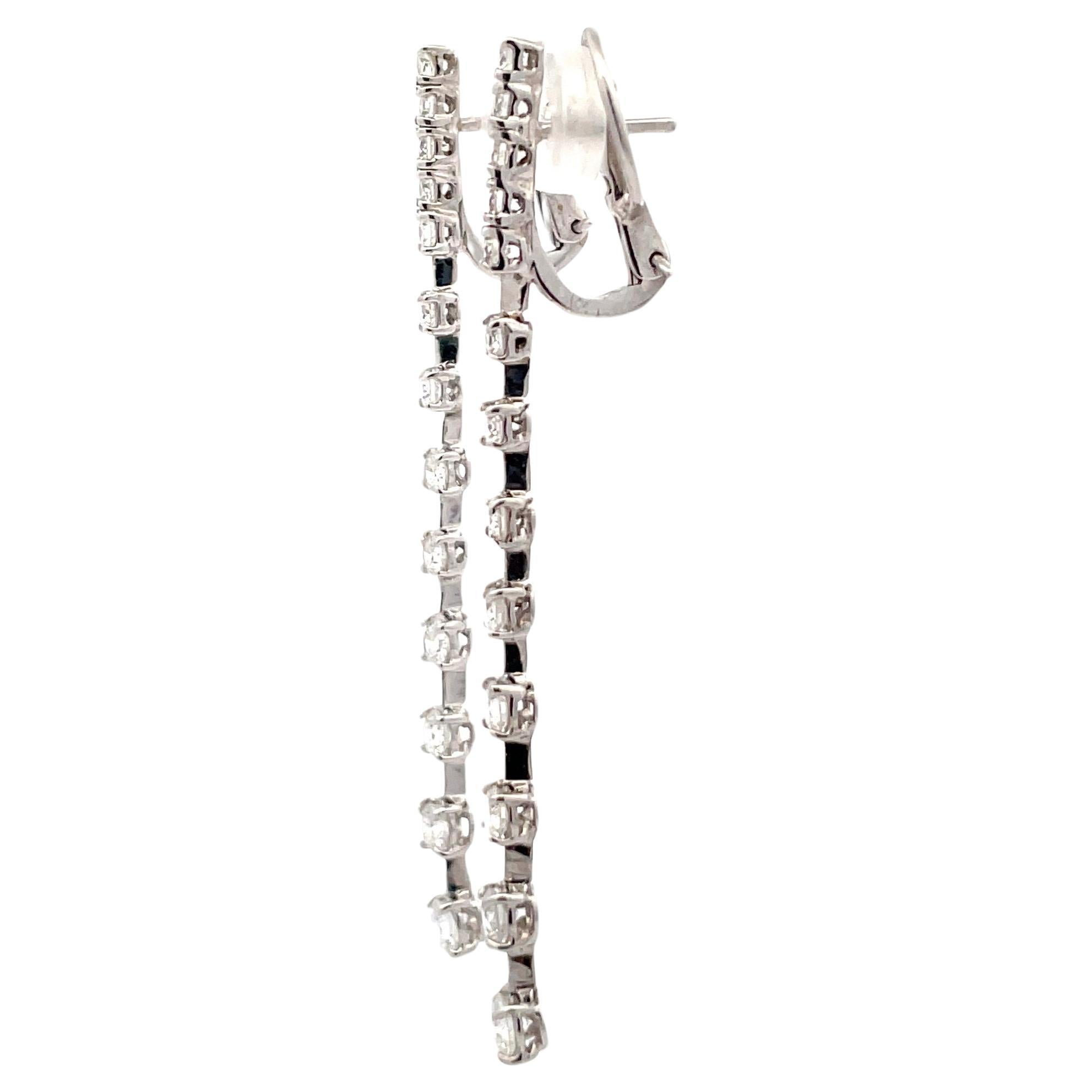 Long dangle drop earrings featuring a top diamond bar containing 10 round brilliants weighing 1.05 carats, 14 round brilliance, weighing 0.69 carats and two bottom round brilliants, 0.37 carats, and 18 karat white gold.