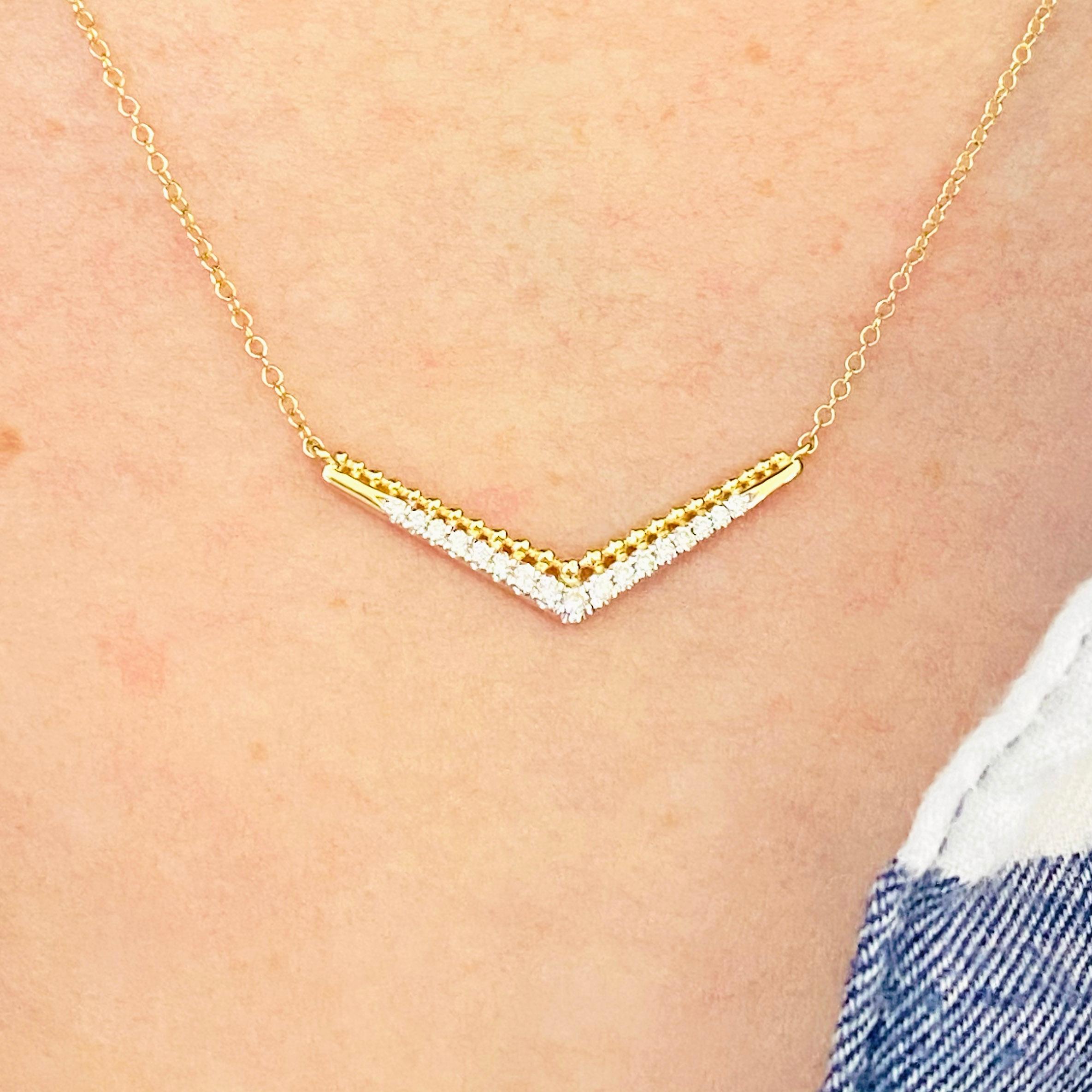 This gorgeous 14k yellow gold beaded chevron bar necklace dripping with brilliant diamonds is sure to put a smile on anyone's face! This necklace looks beautiful worn by itself and also looks wonderful in a necklace stack. This necklace would make a