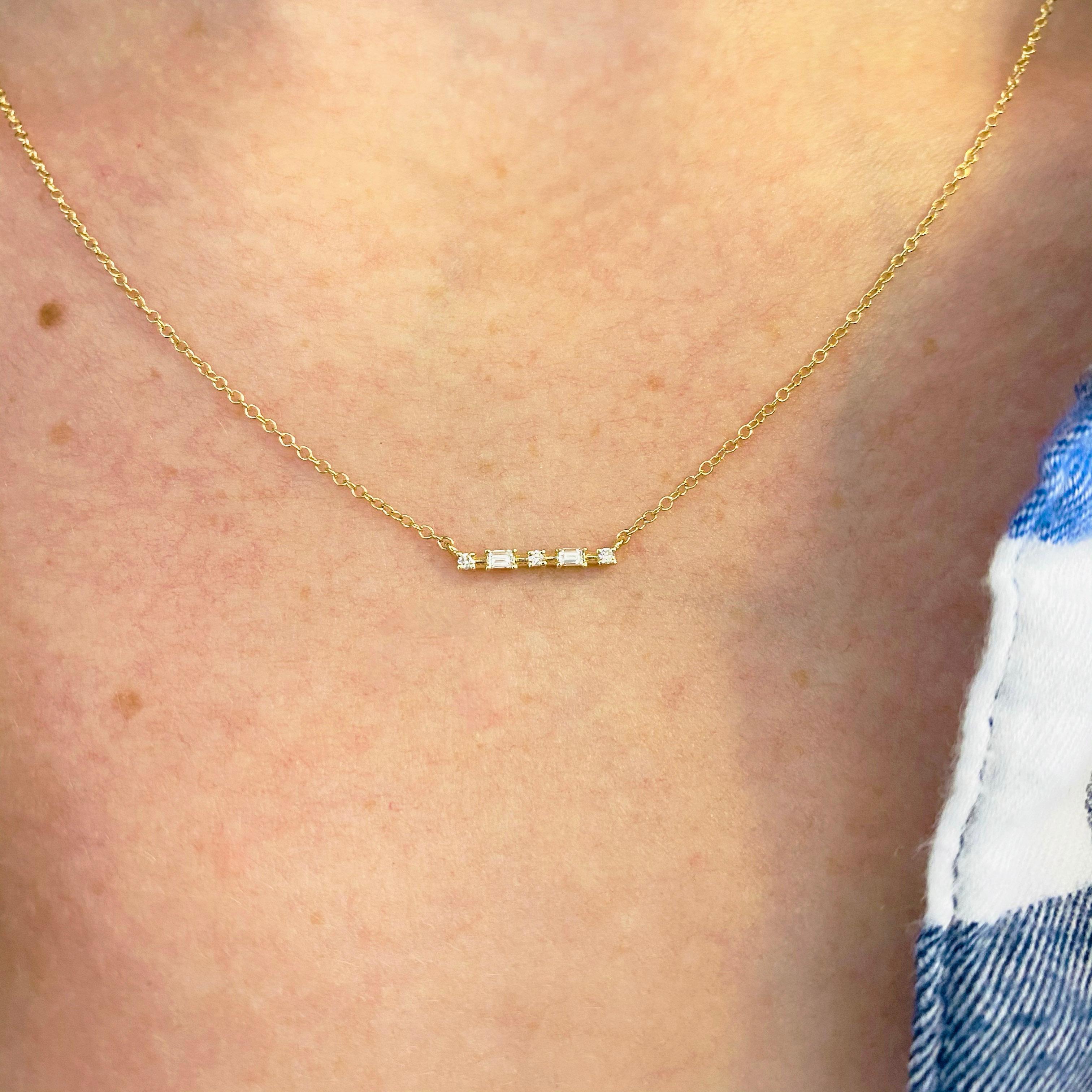 This gorgeous 14k yellow gold bar pendant is stationed with five brilliant diamonds and is sure to put a smile on anyone's face! The diamond stations resembles a constellation of bright white stars (diamonds) sparkling from every angle. This