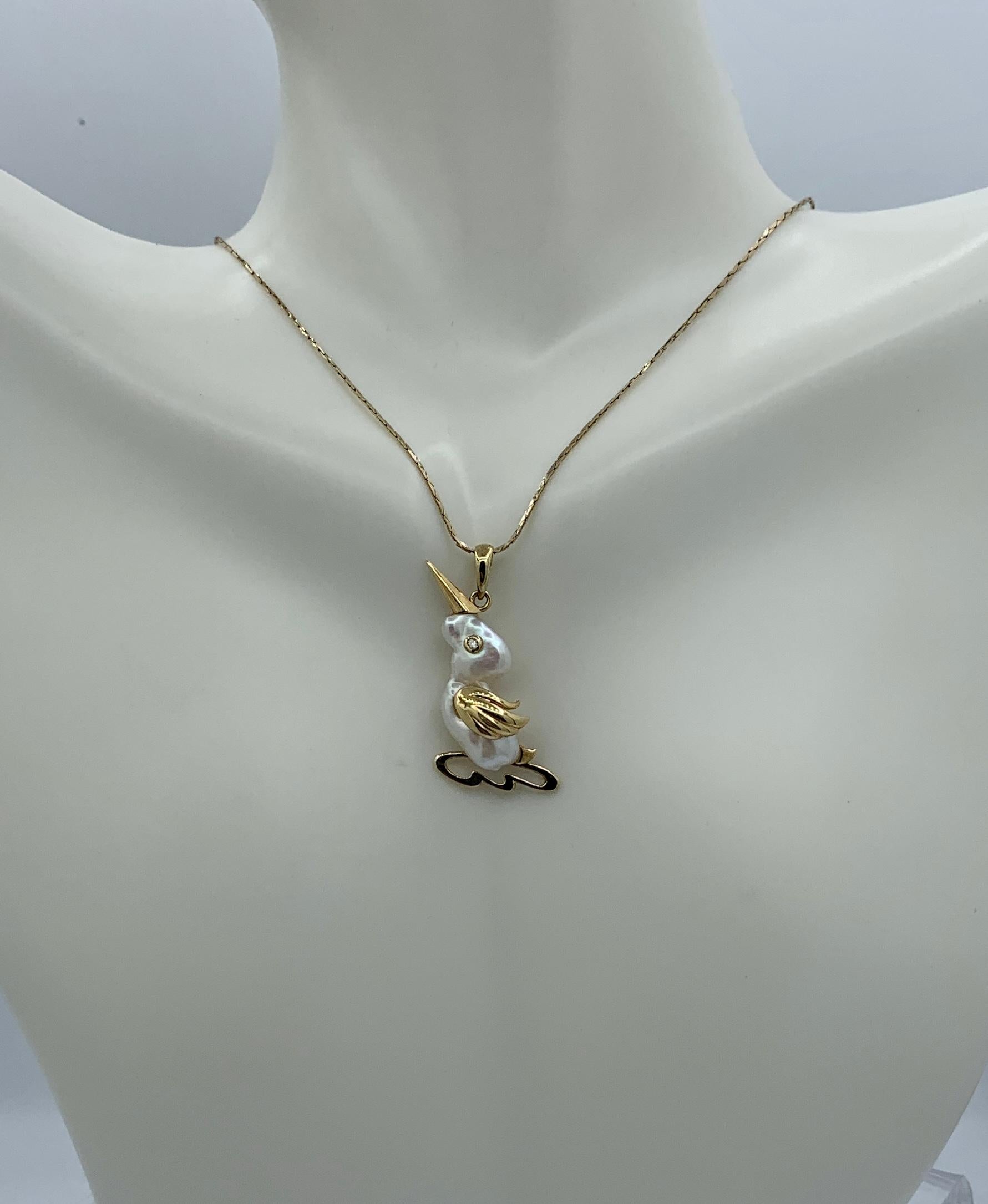 This is a wonderful Baroque Pearl and Diamond Pendant or Charm in the form of a fabulous Bird or Duck in 14 Karat Yellow Gold.  The bird is absolutely charming and has wonderful details in the elegant gold work.  A magnificent natural Baroque Pearl
