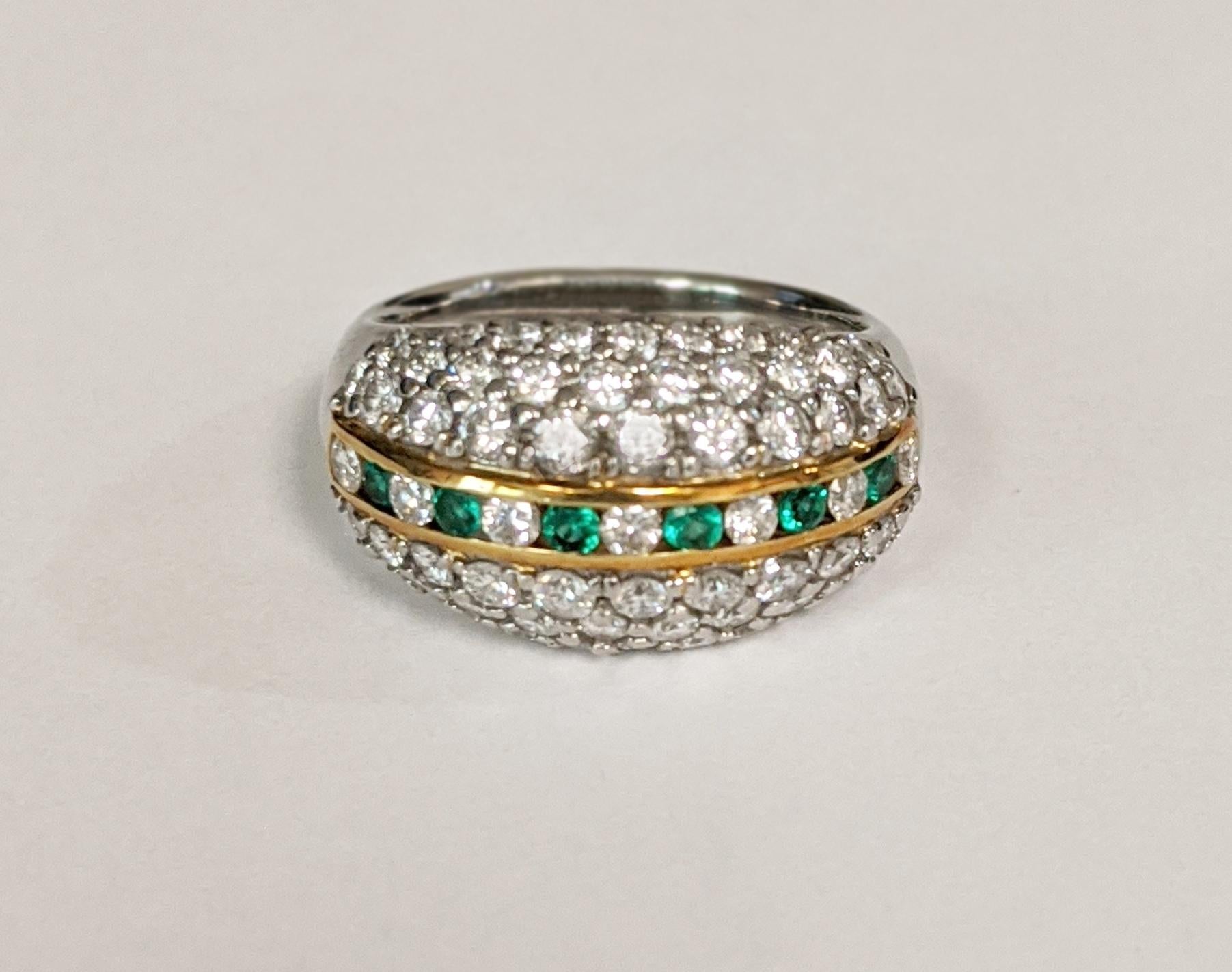 Bead-set round brilliant diamonds cover the dome of this retro ring, separated in the center by a channel of alternating round emeralds and diamonds. Handcrafted in platinum with yellow gold accents.

The ring contains approximately 63 round